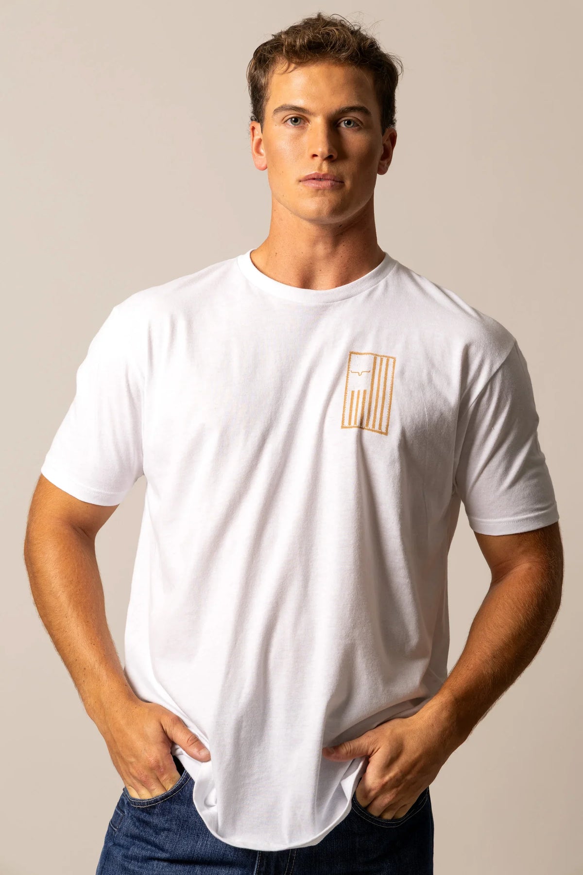 Kimes Ranch Patched White short sleeve shirt with a gold embroidered logo on the chest