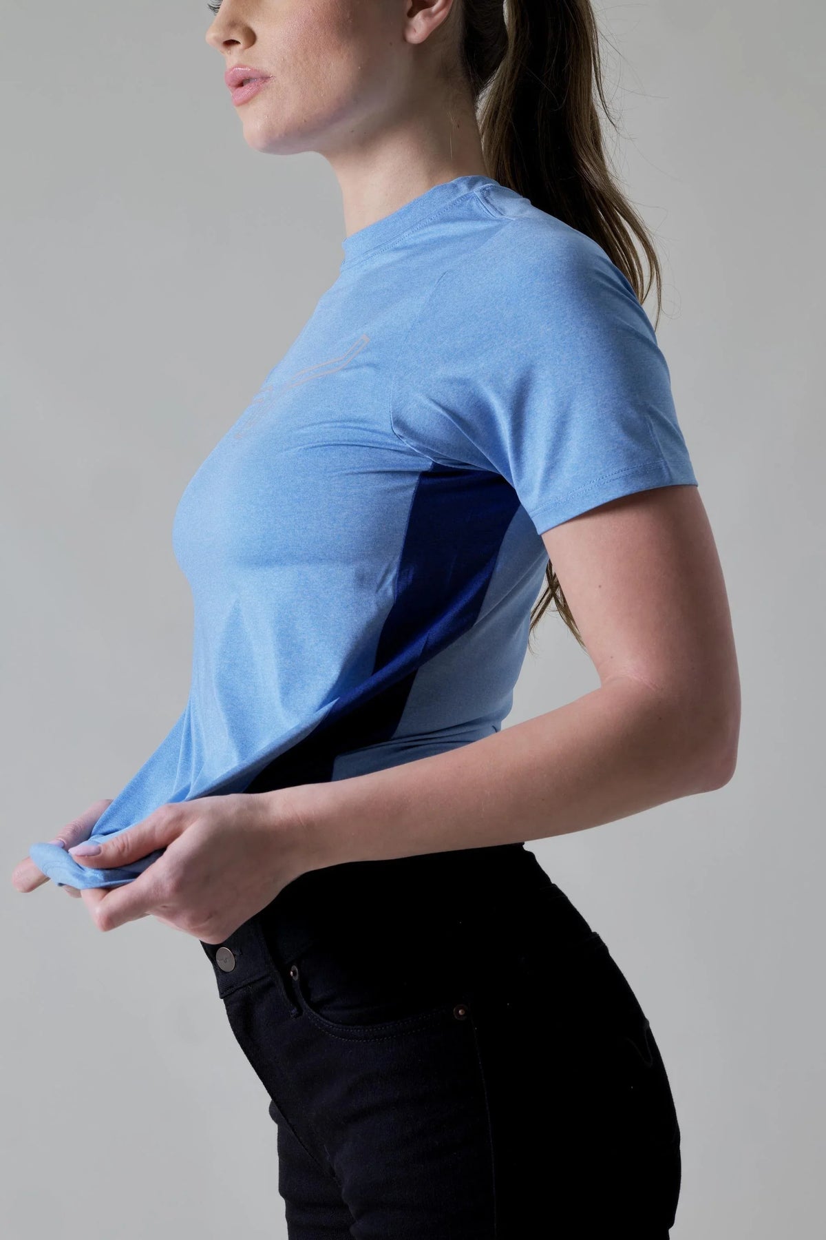 Kimes Ranch Ladies Phase 2 Tech Shirt in Turq Heather, side view, with navy side panels