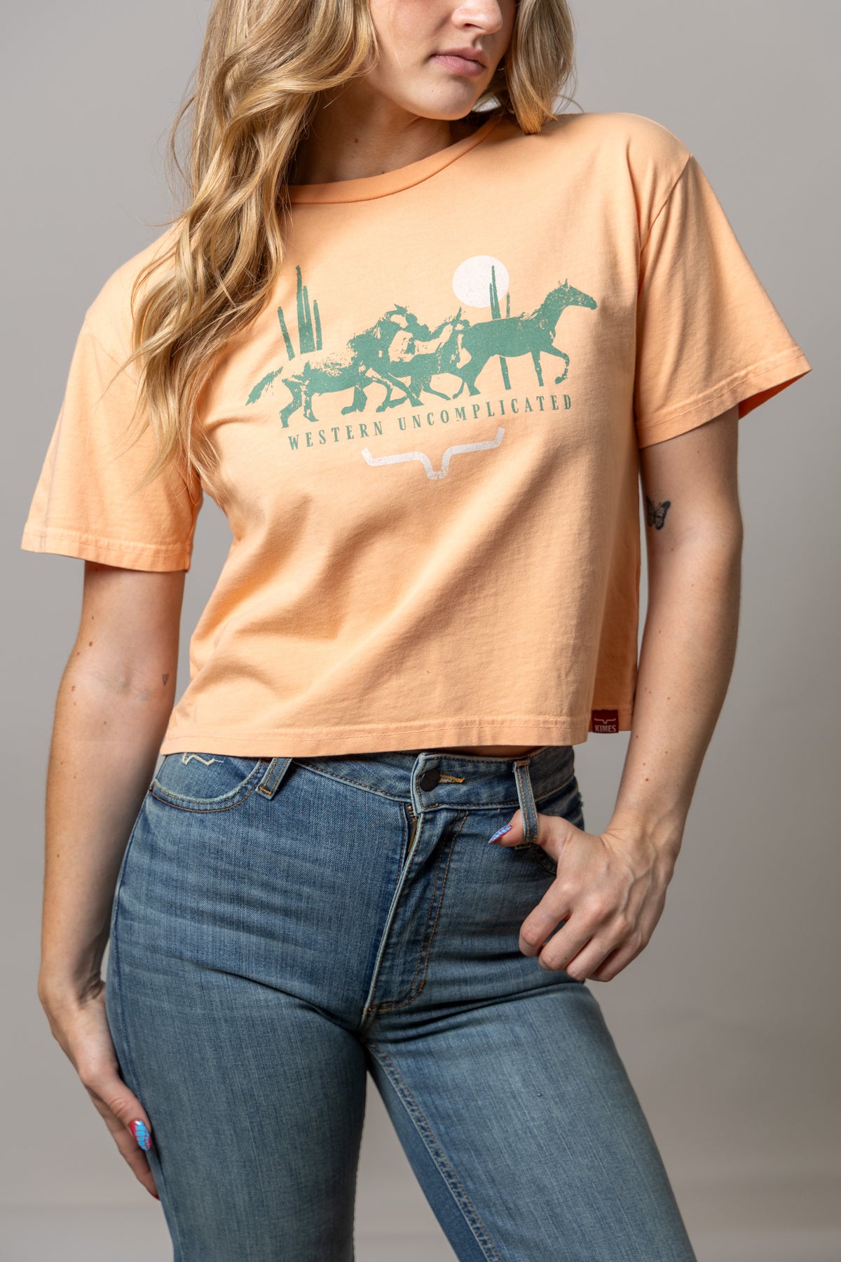 Kimes Ranch Plains Stampede shirt in Peach with a Western Uncomplicated graphic of horses and cacti