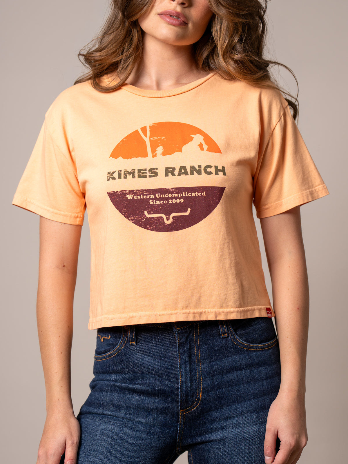 Kimes Ranch Rancher shirt in Peach with a vintage sunset graphic and Kimes Ranch logo