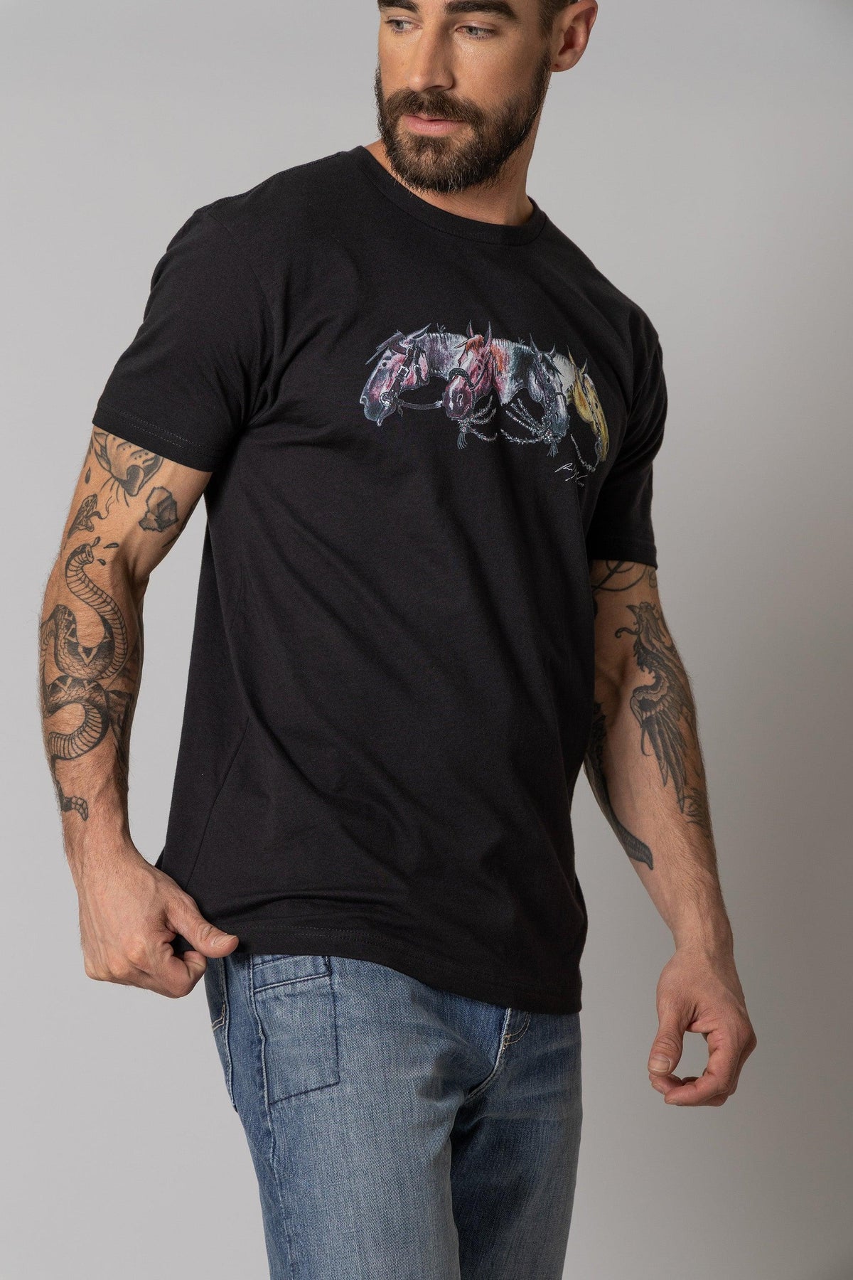 Kimes Ranch Randy Paul NRCHA Derby Tee Shirt in Black, side view, with a graphic of three horses