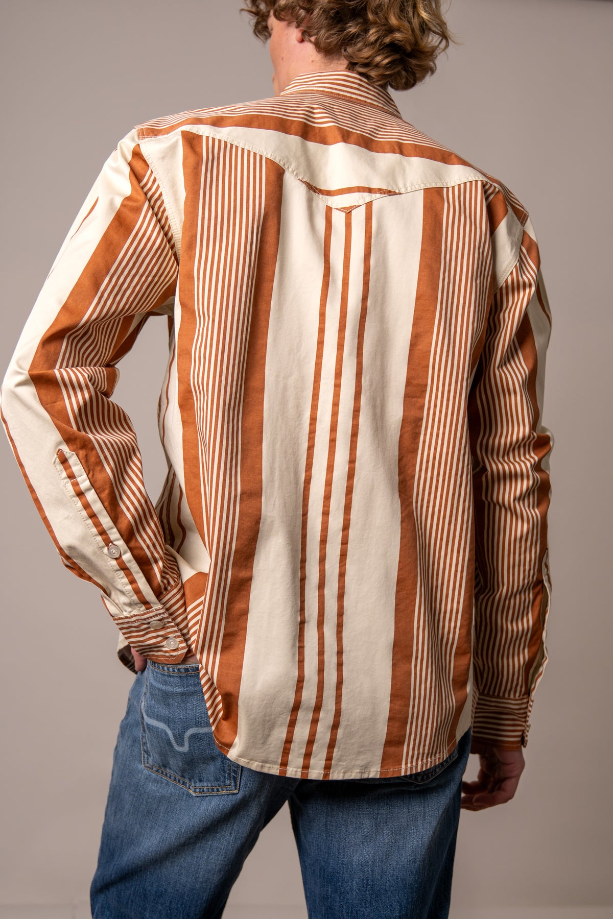 Kimes Ranch Reddy dress shirt in Bran, back view, with wide vertical stripes and a western yoke