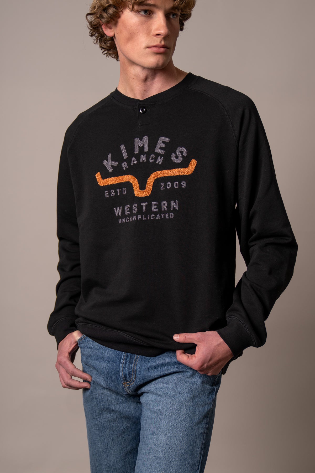 Kimes Ranch Reeves sweatshirt in Black with a graphic featuring the Kimes Ranch logo and text reading Western Uncomplicated