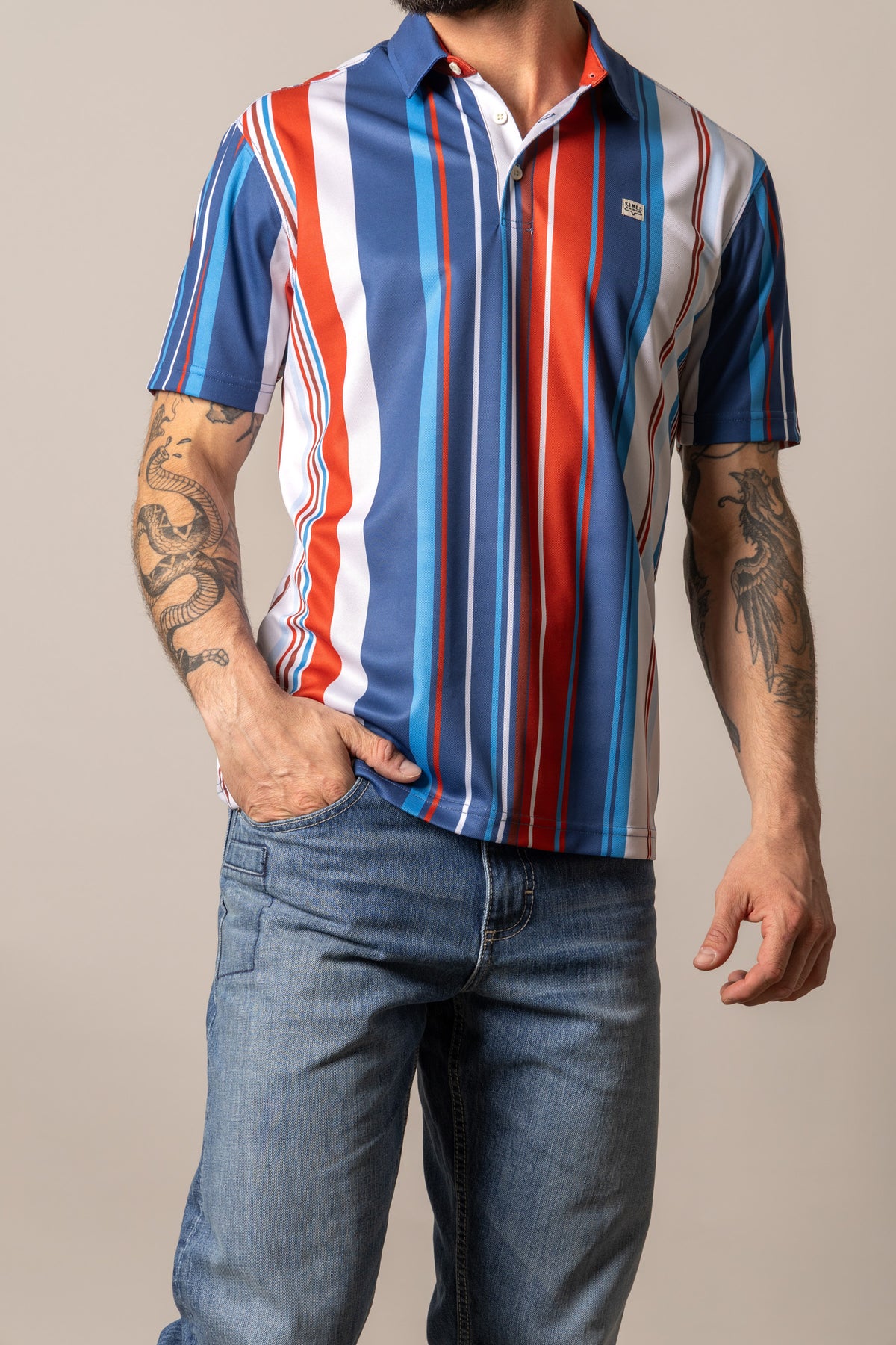 Kimes Ranch Rein polo shirt in Blue with vertical stripes in red, white, and light Blue with a collar and short sleeves