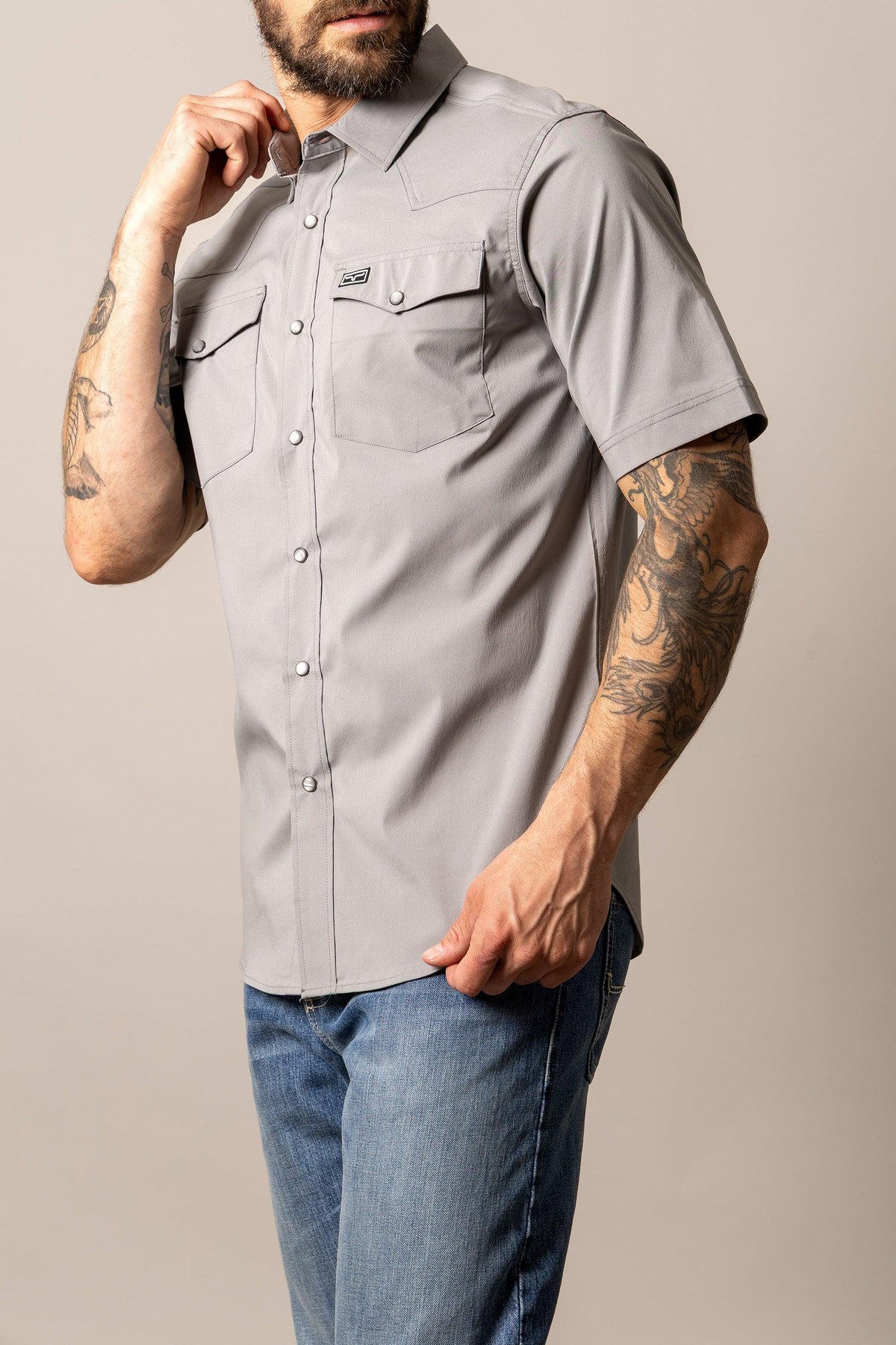 Kimes Ranch Rio Short Sleeve Dress Shirt in Grey, side view, with a western yoke and two button flap chest pockets