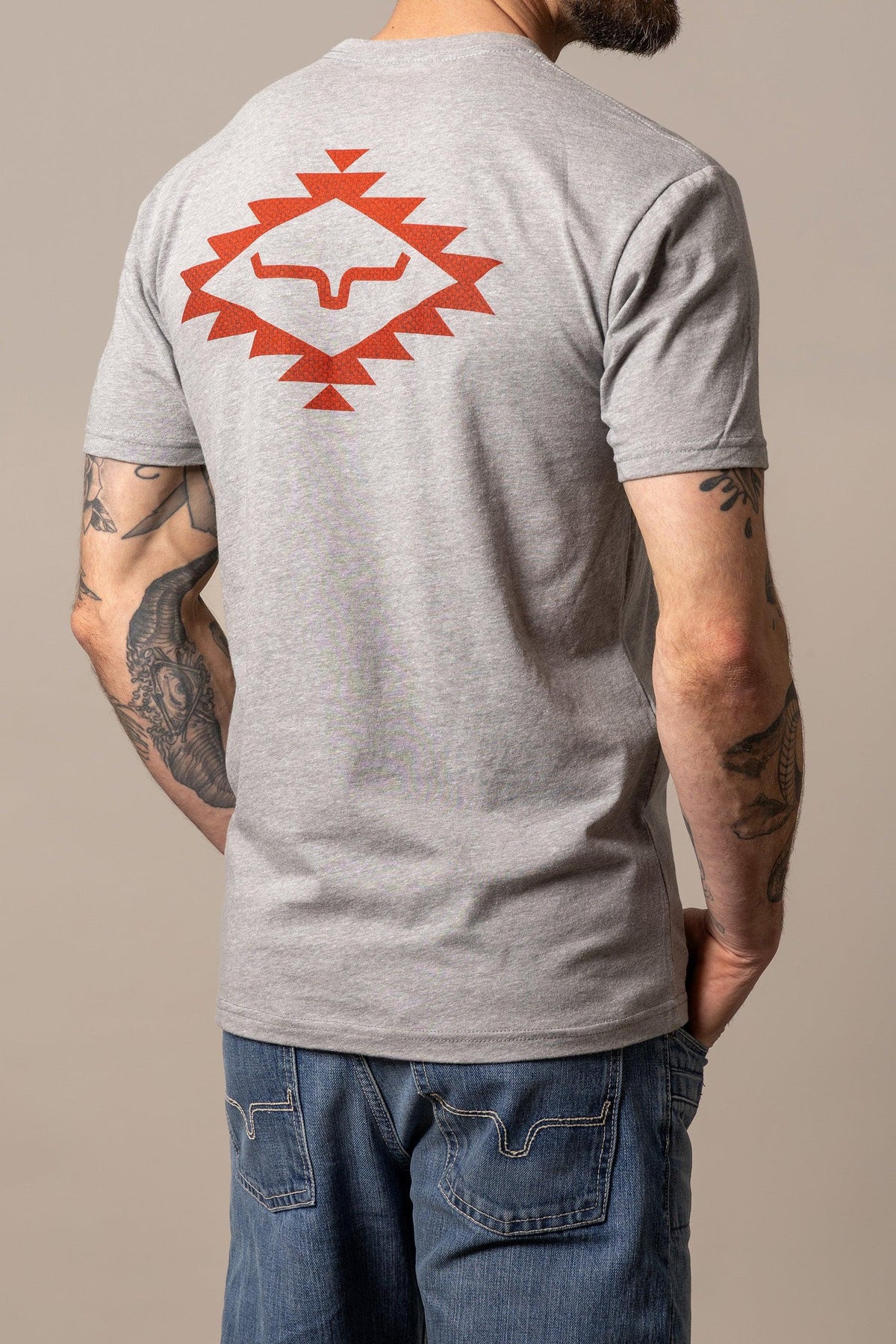 Kimes Ranch San Juan shirt in Dark Grey Heather, back view, with a large orange geometric longhorn logo on the back