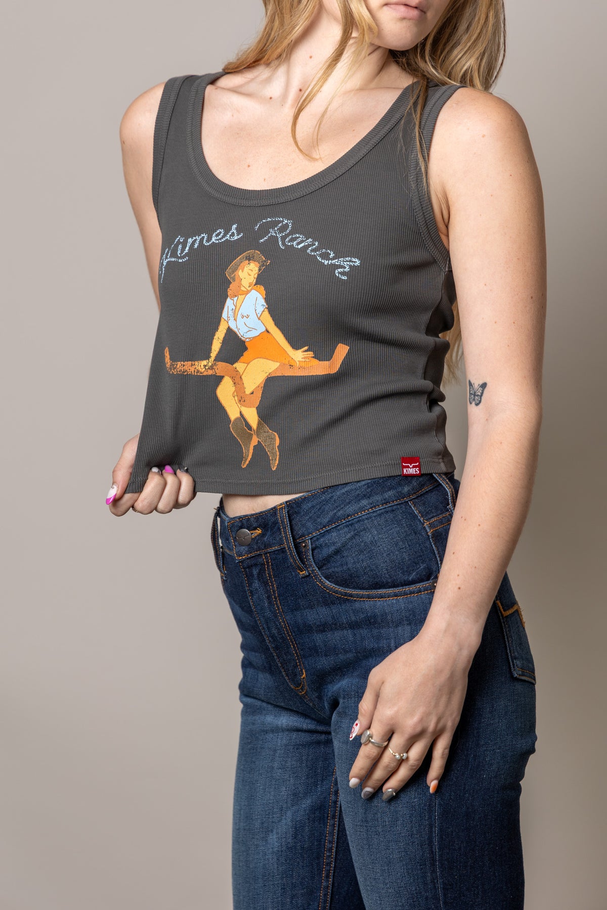Kimes Ranch See Saw Black tank top with a graphic of a girl on a seesaw and Kimes Ranch logo