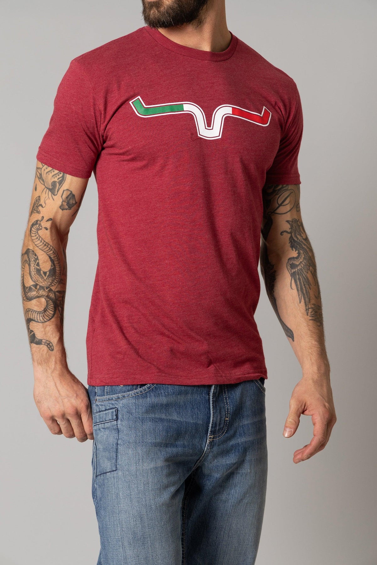 Kimes Ranch Semana Shirt in Cardinal with a stylized steer logo graphic across the chest in green, white, and red