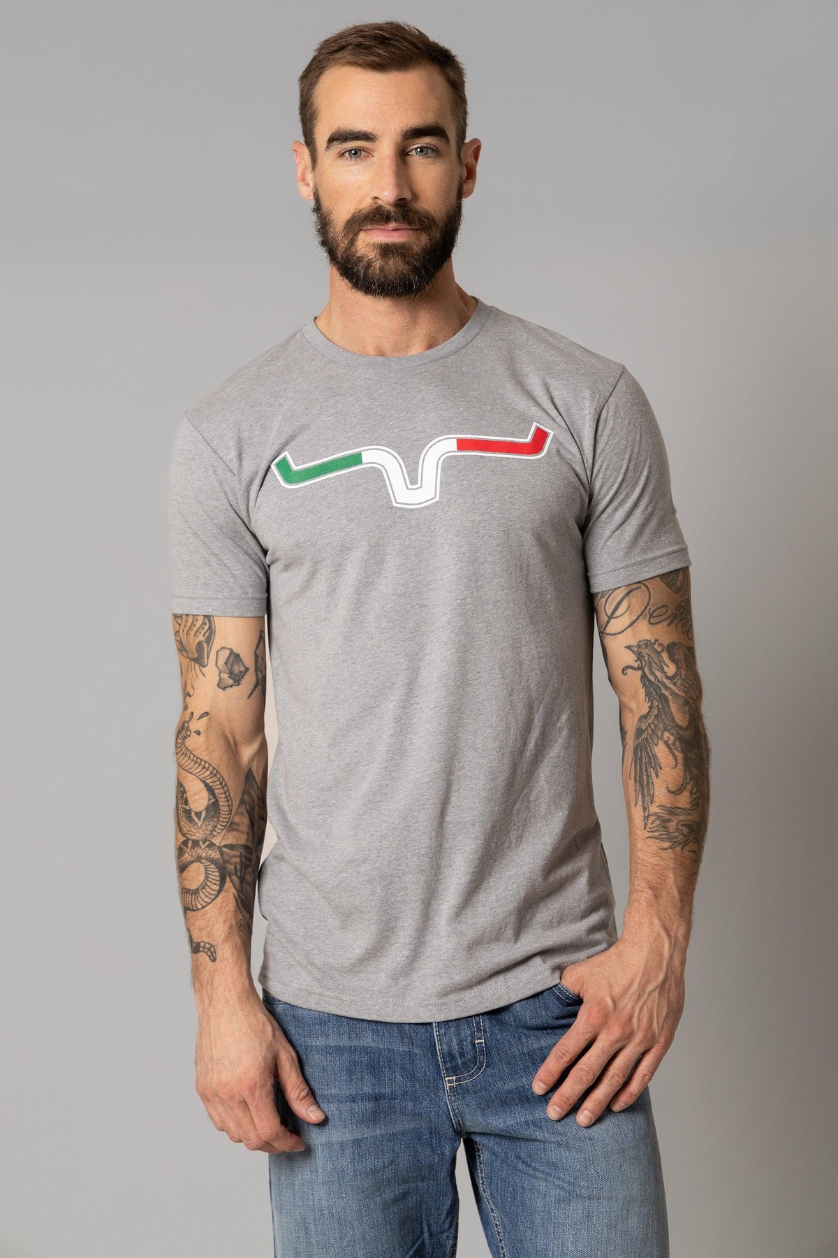 Kimes Ranch Semana Shirt in Grey Heather with a graphic of a stylized Kimes Ranch logo in green, white, and red