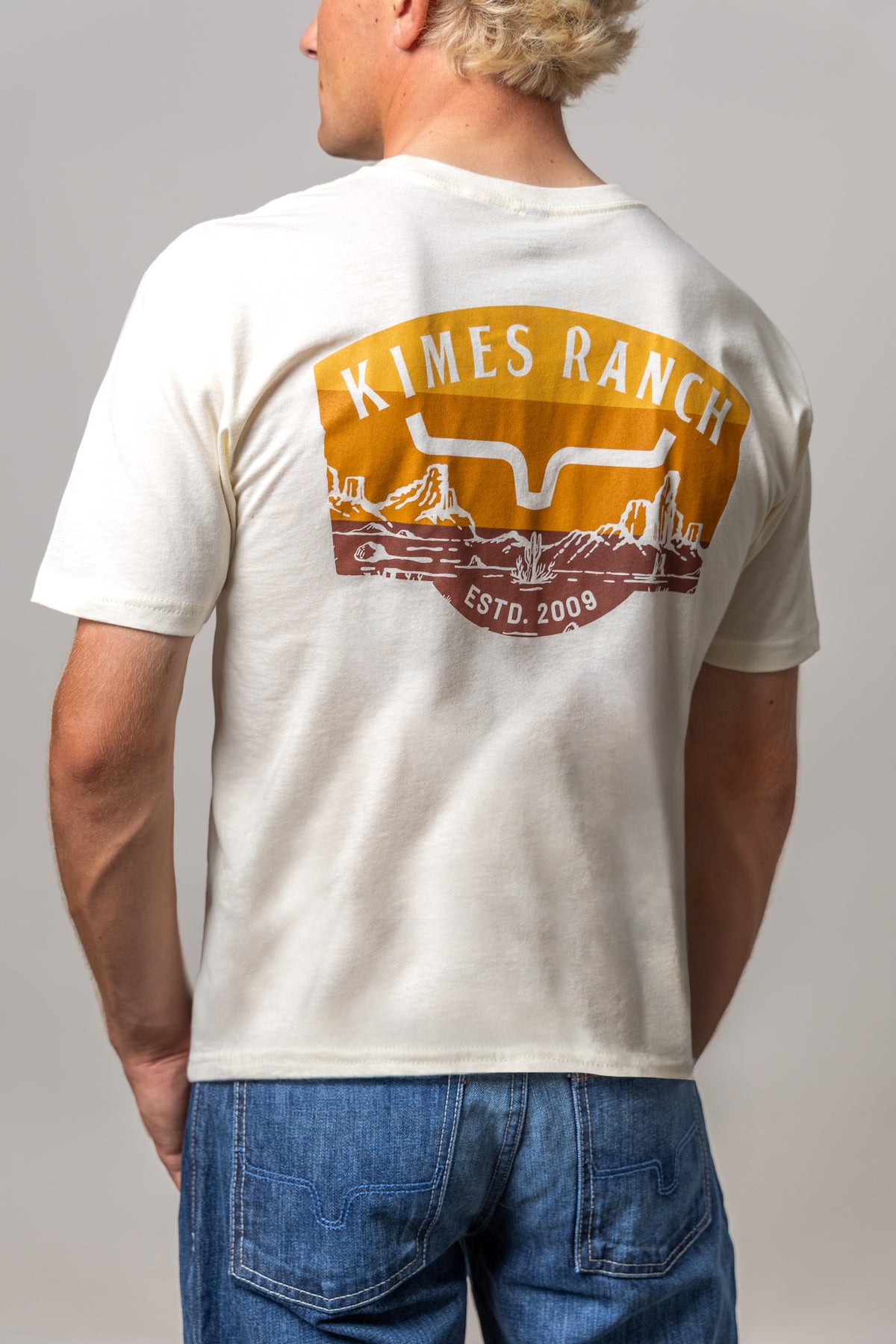 Kimes Ranch Southwestern, back view, shirt back with a graphic of the Kimes Ranch logo and desert landscape
