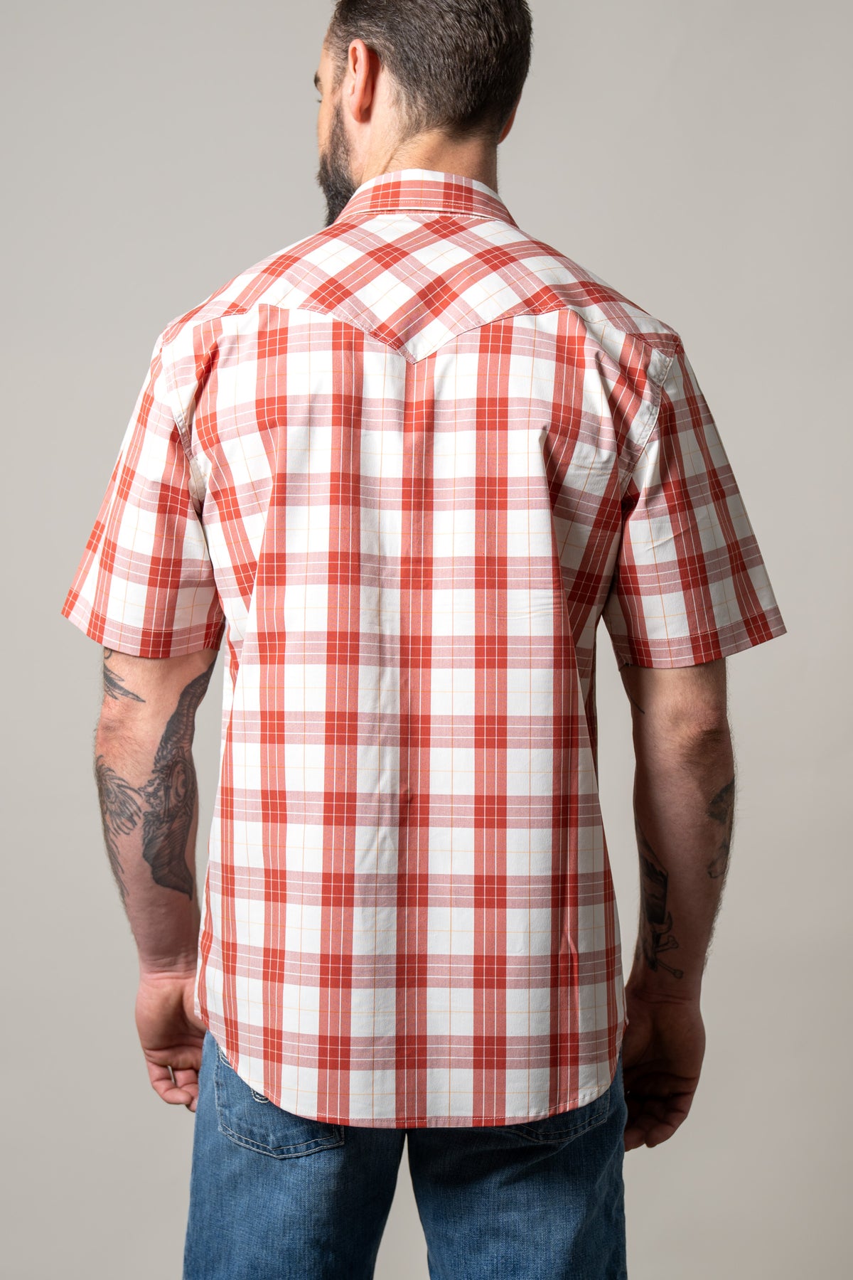 Kimes Ranch Spade dress shirt in Brick Red, back view, with a short sleeve plaid pattern and a back yoke