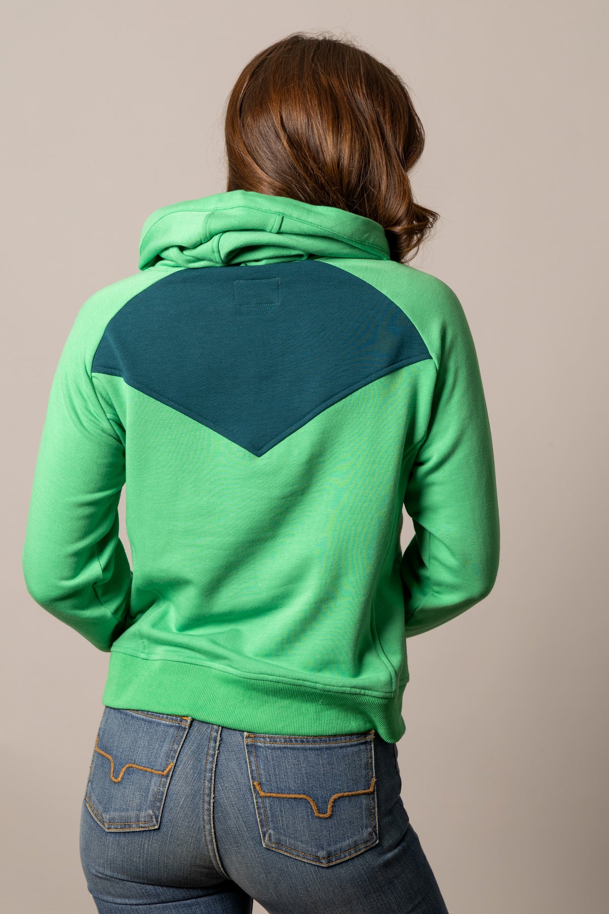 Kimes Ranch Stella hoodie in Kelly Green, back view, with a teal yoke and hood