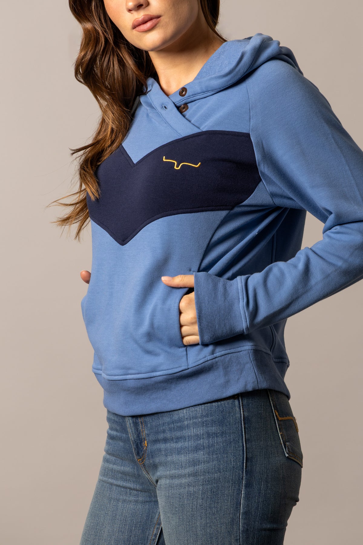 Kimes Ranch Stella hoodie in Mid Blue, side view, with a navy chest panel and embroidered logo