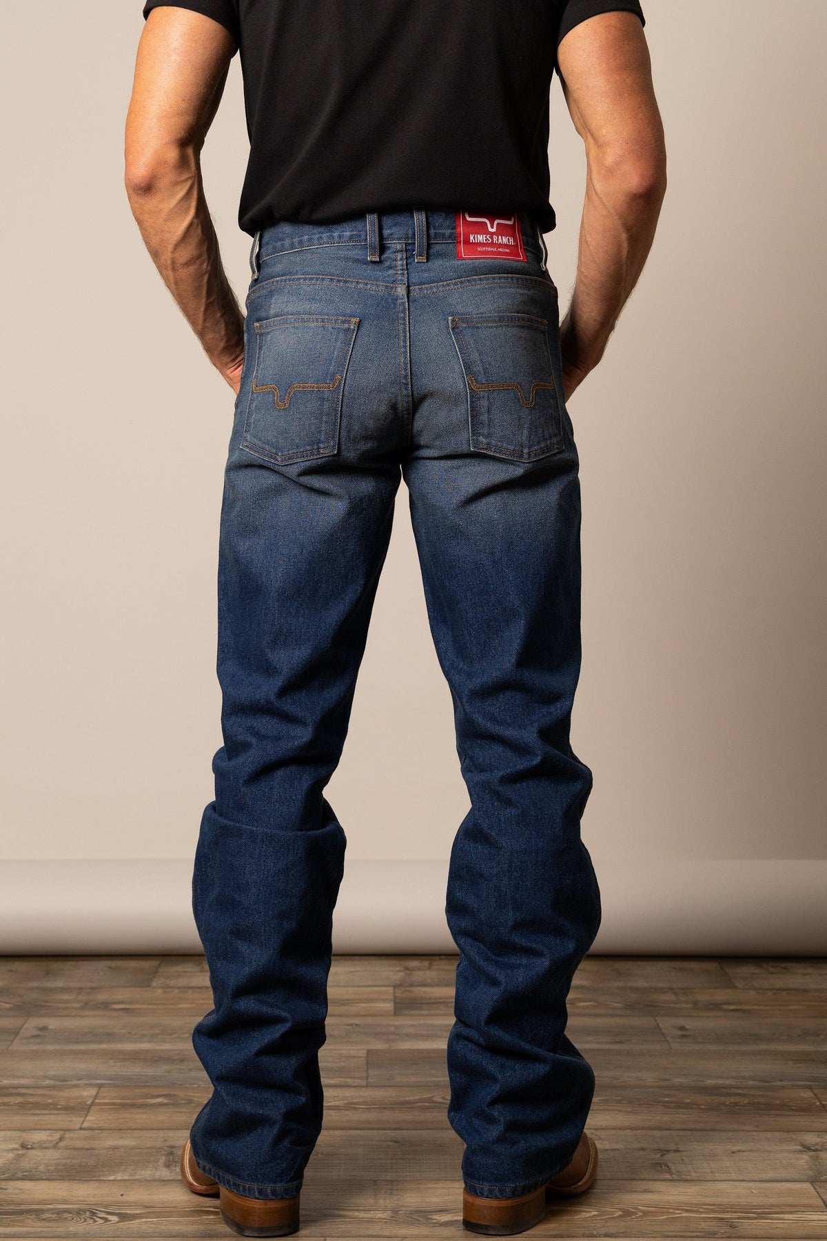 Kimes Ranch Stewart Relaxed Bootcut jeans in Dark Wash, back view, with back pockets and red logo patch