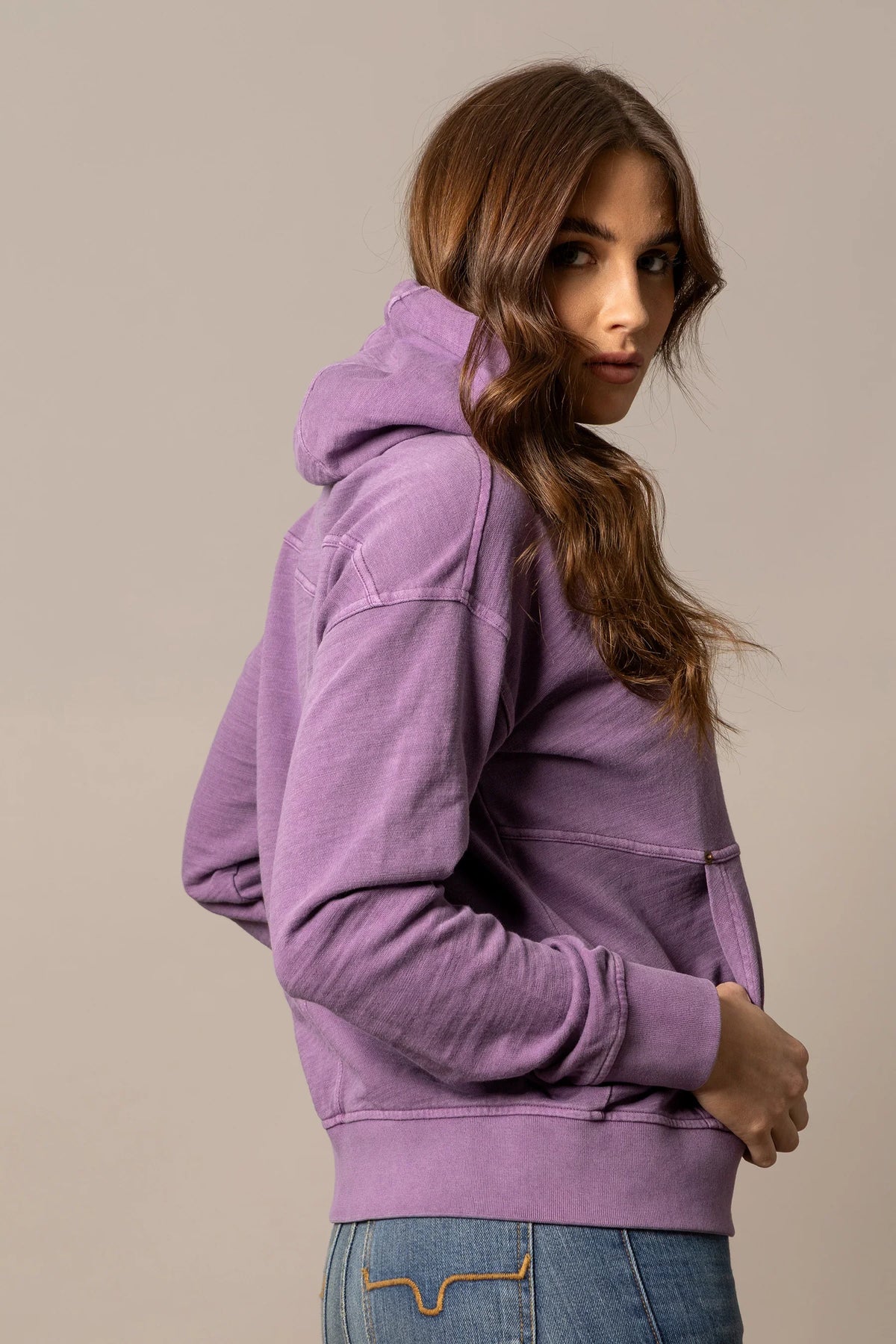 Kimes Ranch Tess Western Hoodie in Plum, side view, with a kangaroo pocket and ribbed cuffs