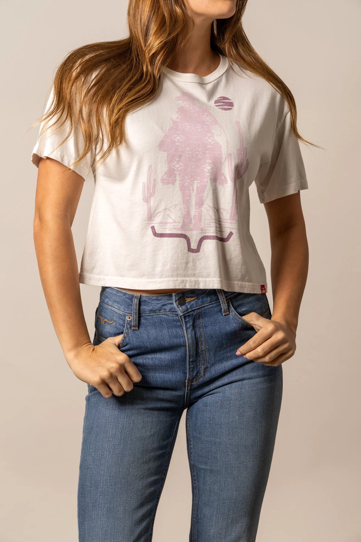 Kimes Ranch The Road shirt in Bone with a pink graphic of the Kimes Ranch logo with cacti