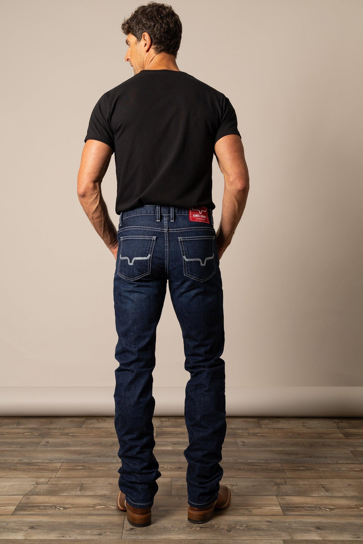 Kimes Ranch Thomas Straight Fit Bootcut jeans in dark blue with signature white stitching on the back pockets