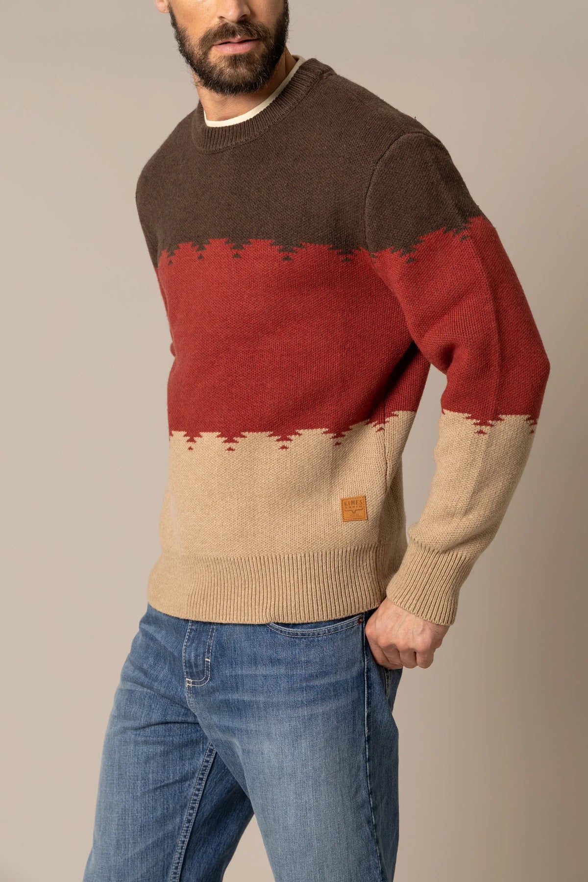 Kimes Ranch Trey Crew sweatshirt in Dark Brown, side view, with red and tan color blocking and a logo patch