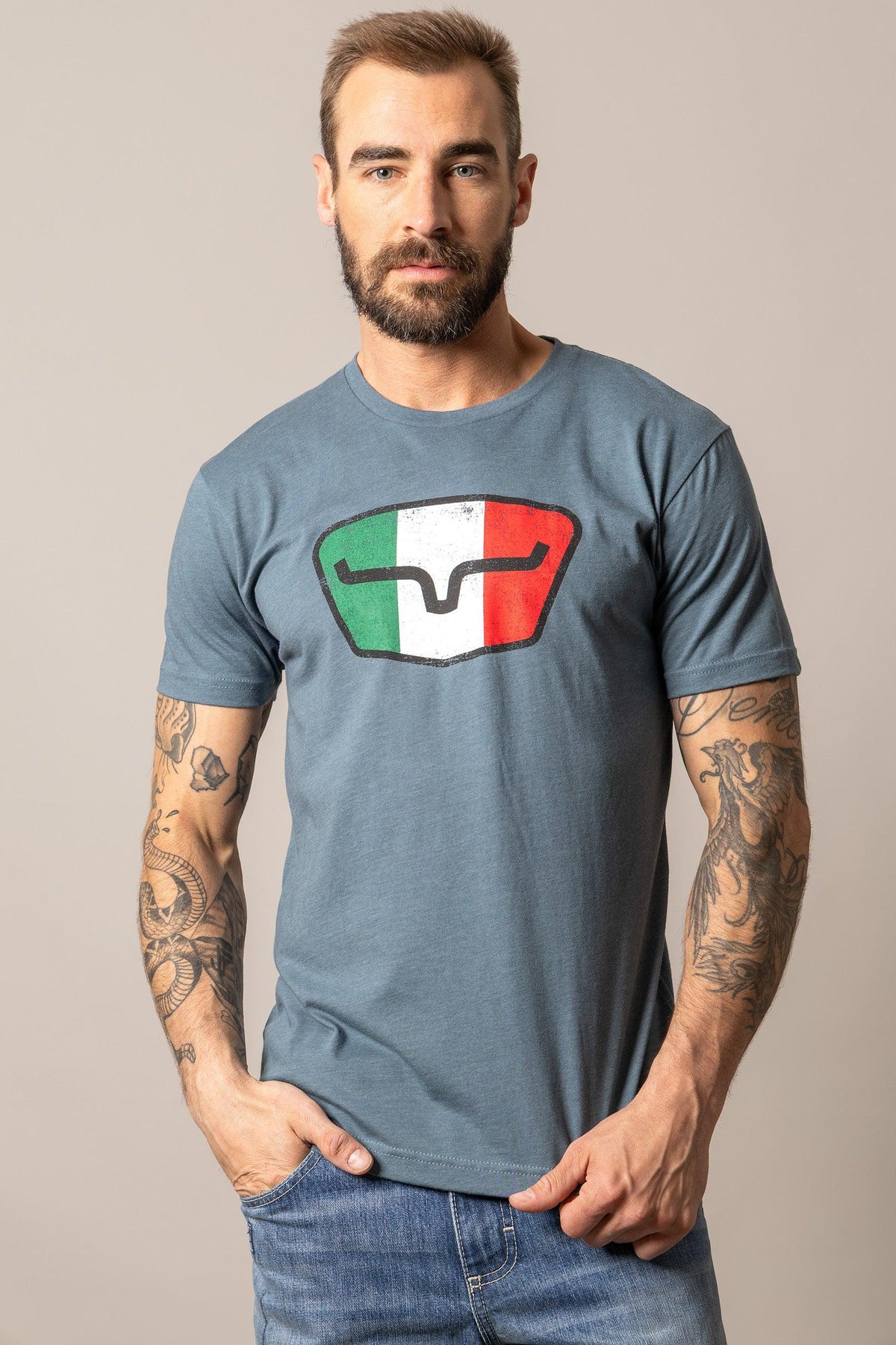 Kimes Ranch Tri-Color Tee in Indigo with a shield graphic featuring green, white, and red vertical stripes