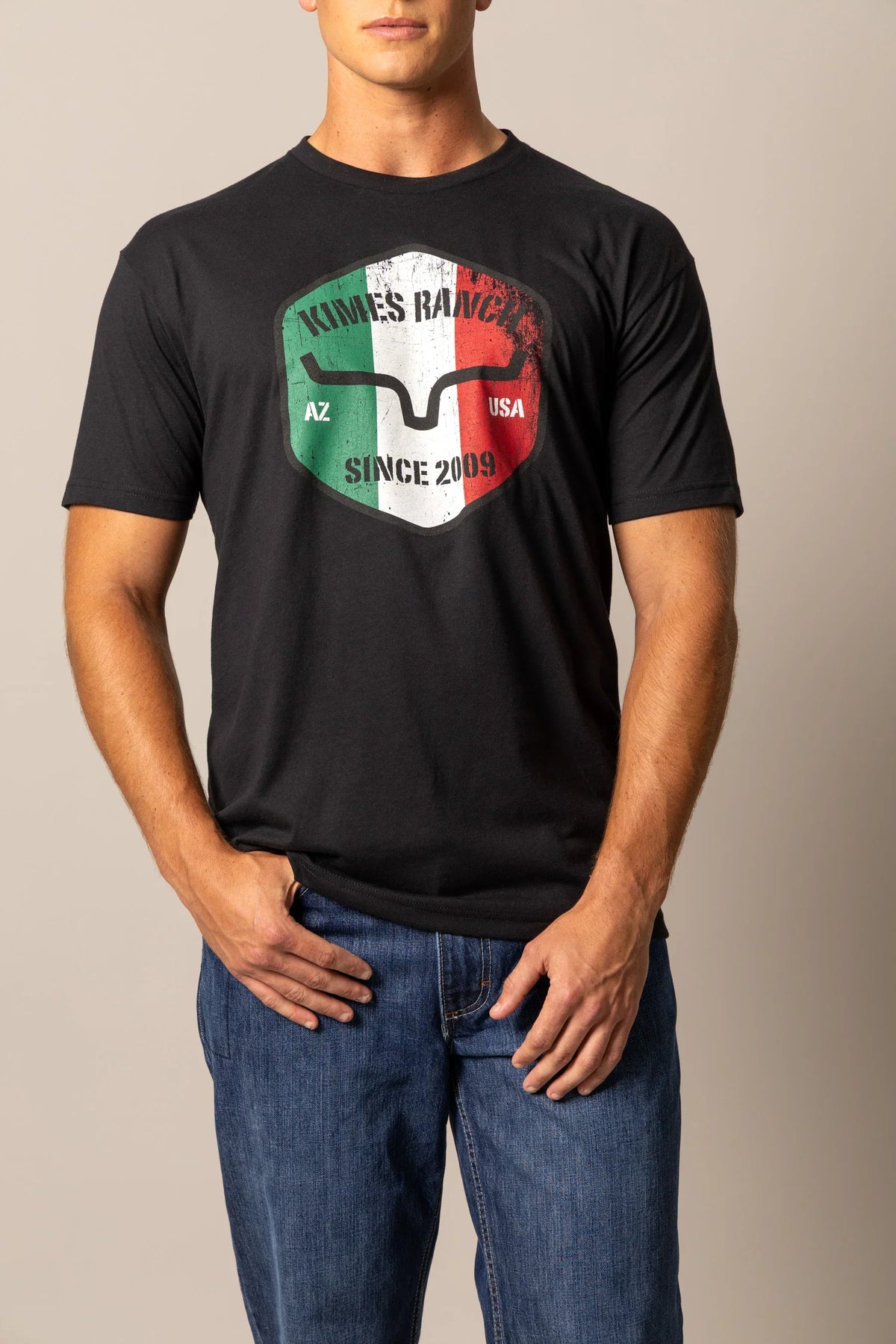 Kimes Ranch Triple Stripe shirt in Black with a shield graphic featuring the Kimes Ranch logo and text AZ USA SINCE 2009