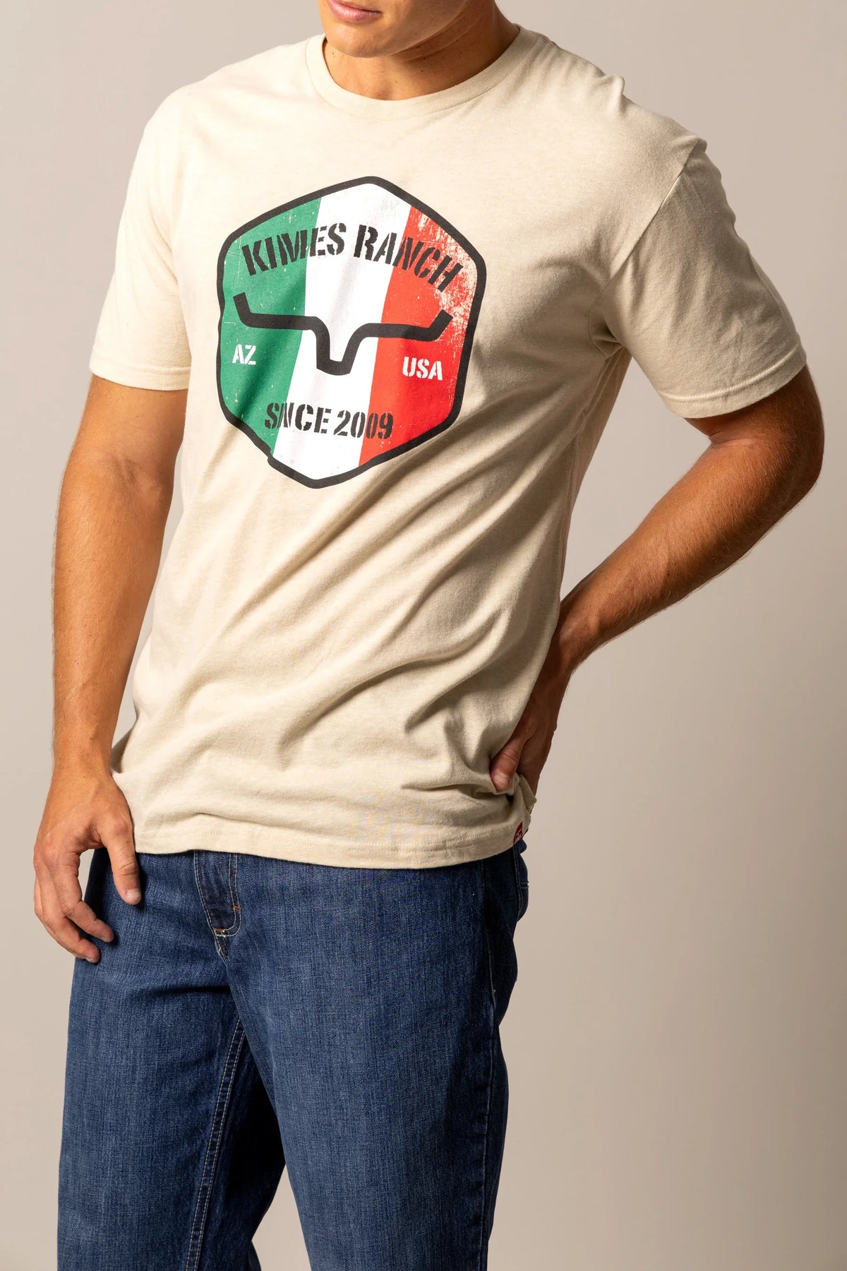 Kimes Ranch Triple Stripe shirt in Natural with a shield graphic featuring AZ USA and since 2009