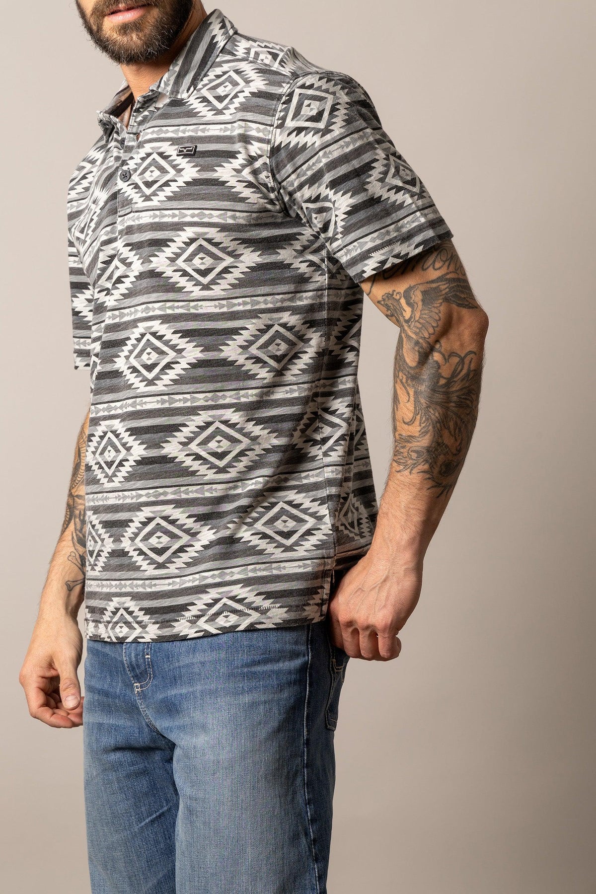 Kimes Ranch Tulum Polo in Grey, side view, with a geometric diamond pattern and short sleeves
