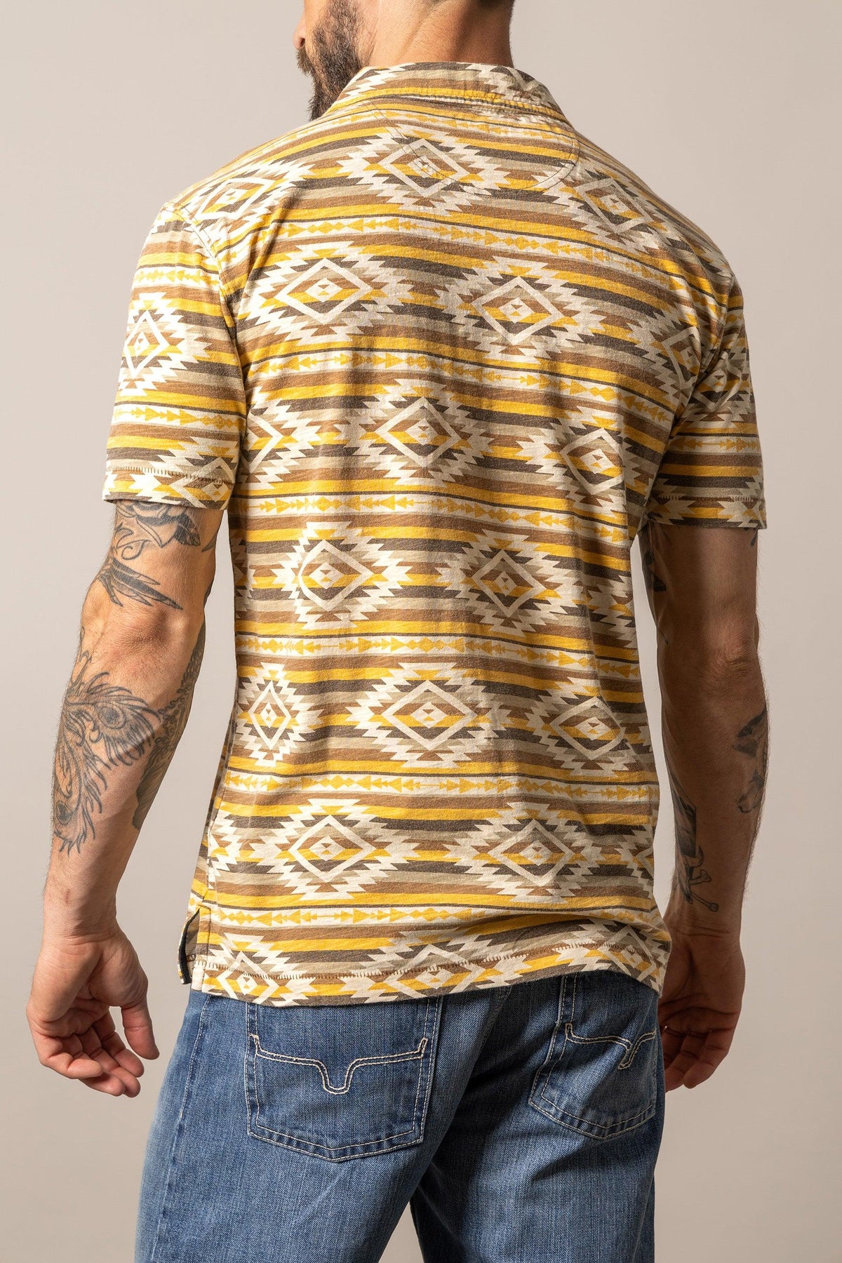 Kimes Ranch Tulum Polo in Gold, back view, with a geometric pattern and short sleeves