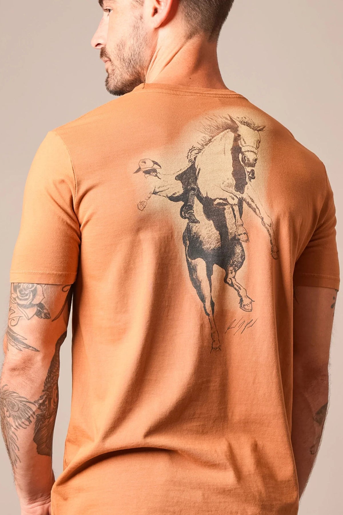 Kimes Ranch Uh Oh RP shirt in Work Wear Brown, back view, with a back graphic of a cowboy riding a bucking horse