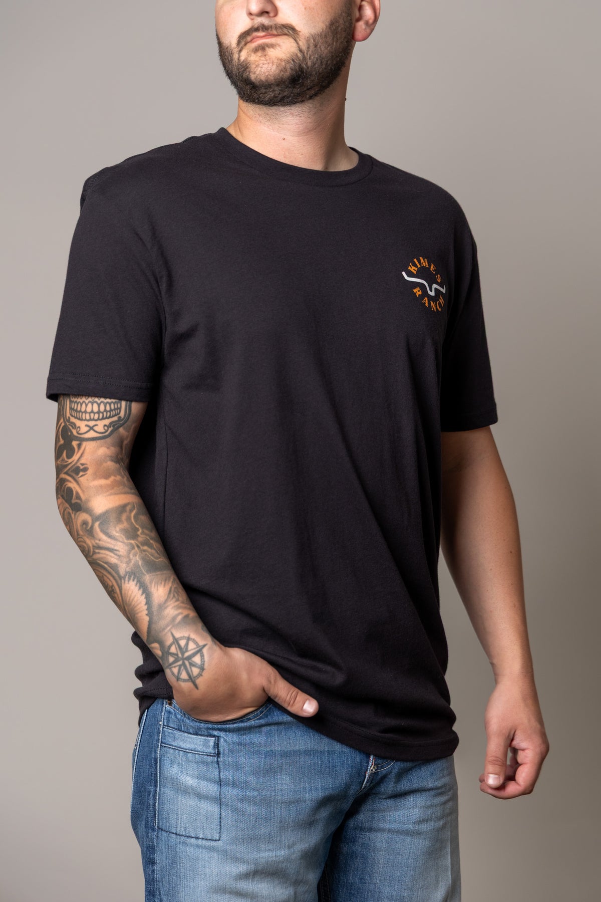 Kimes Ranch Uncomplicated shirt in Black with a crew neck and short sleeves and a Kimes Ranch logo on the chest