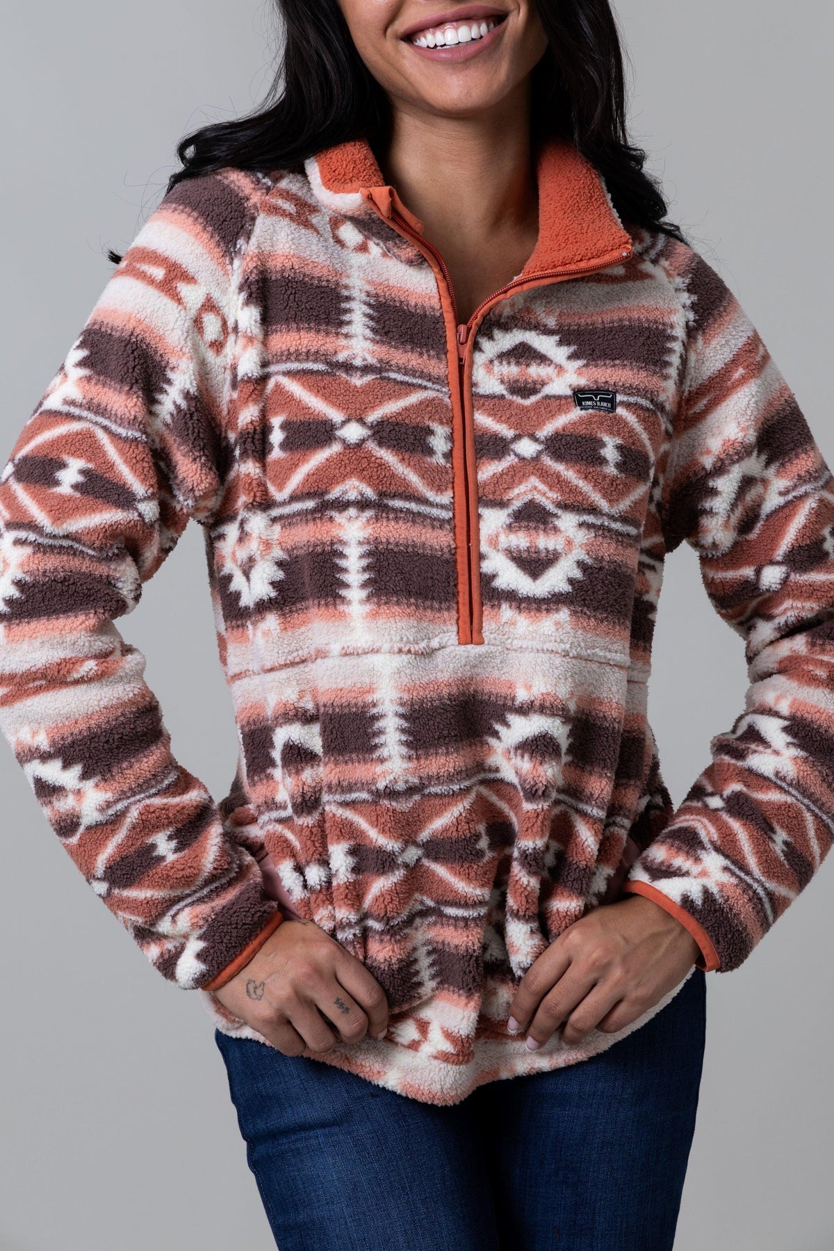 Kimes Ranch Roswell Polar Fleece sweatshirt in Rust Red with a geometric pattern and a half-zip front