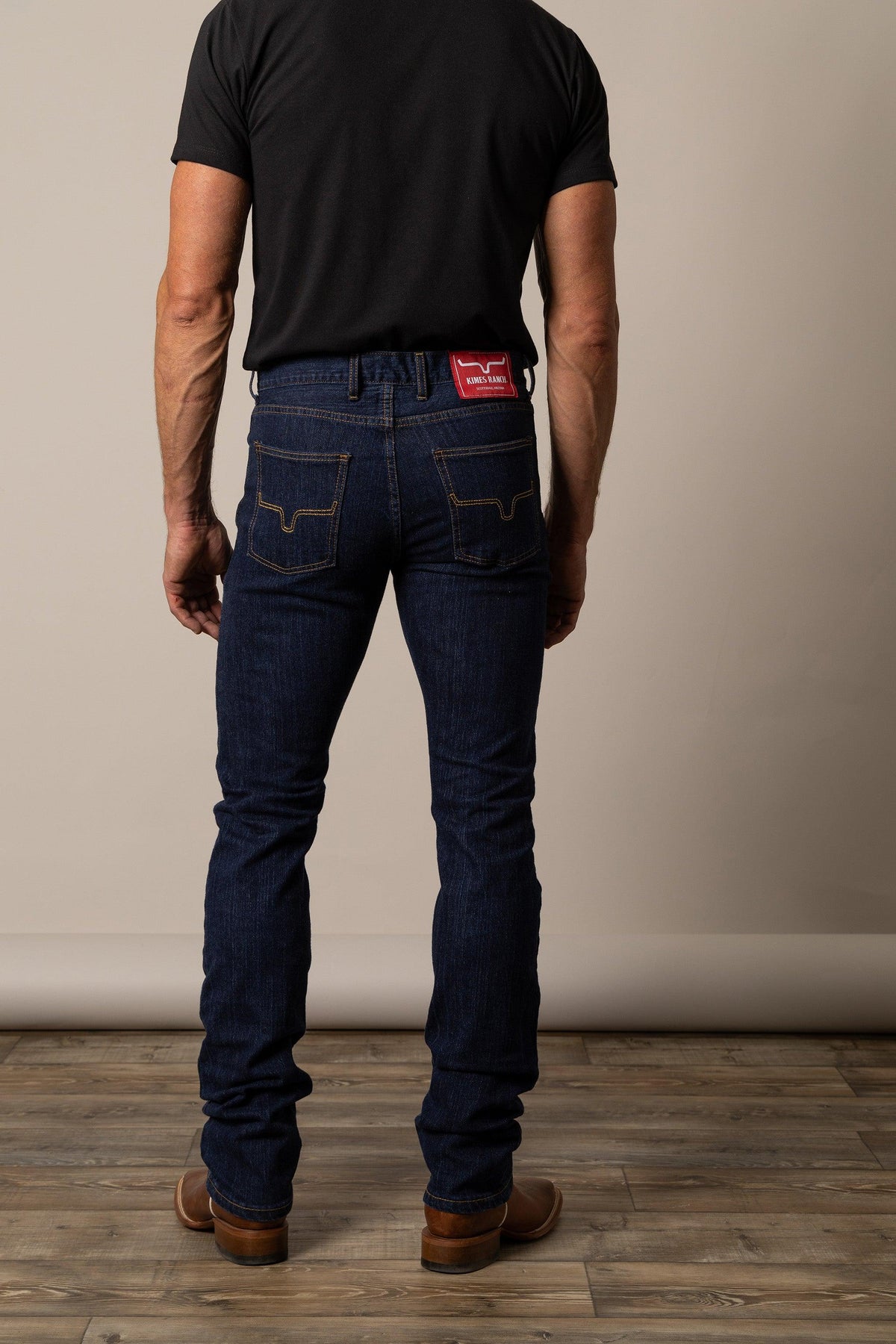 Kimes Ranch Wayne Slim Bootcut jeans in indigo with contrast stitching and a red logo patch at the back waist