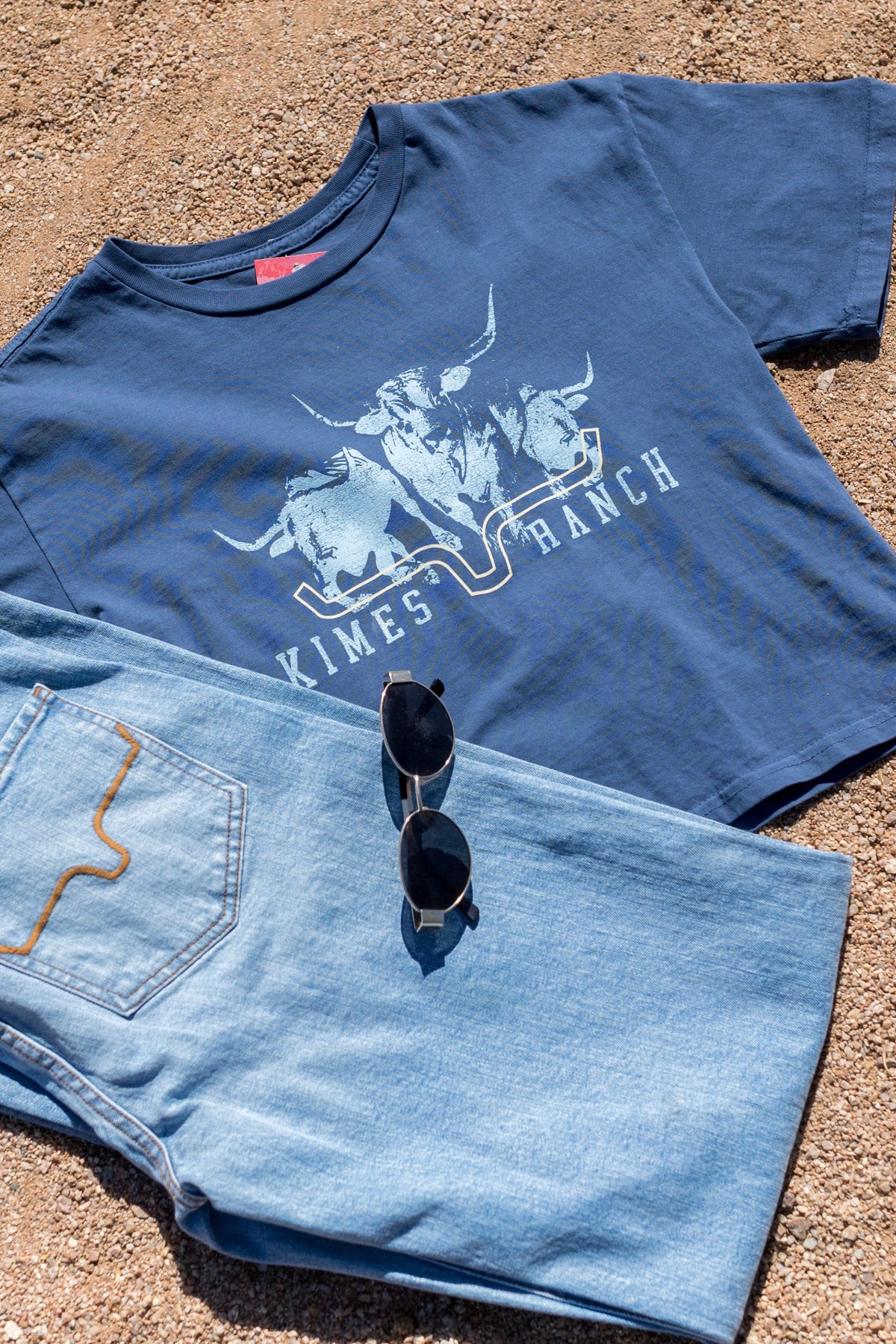 Kimes Ranch Movin' Out shirt in Dark Blue with a graphic of longhorns and the Kimes Ranch logo