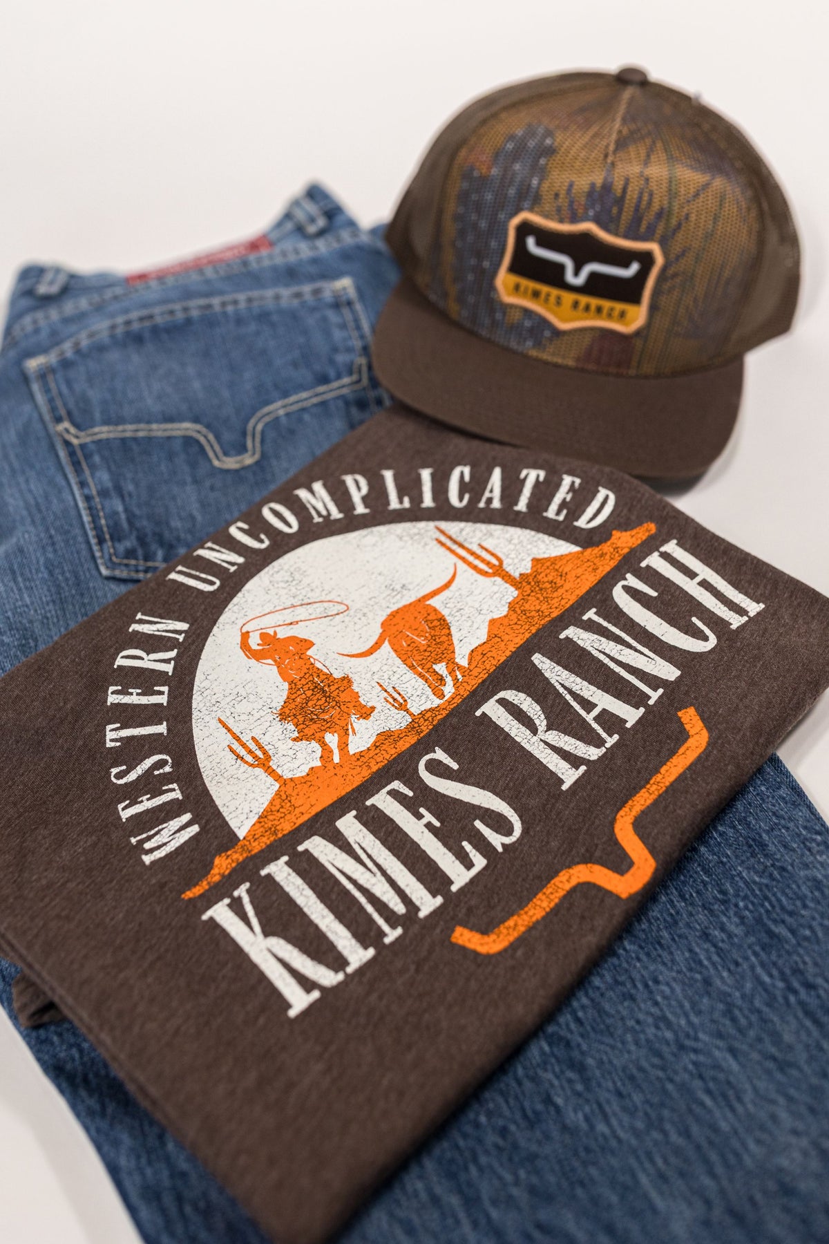 Kimes Ranch The Chase shirt in Espresso, close-up, with a Western Uncomplicated graphic of a cowboy roping a steer