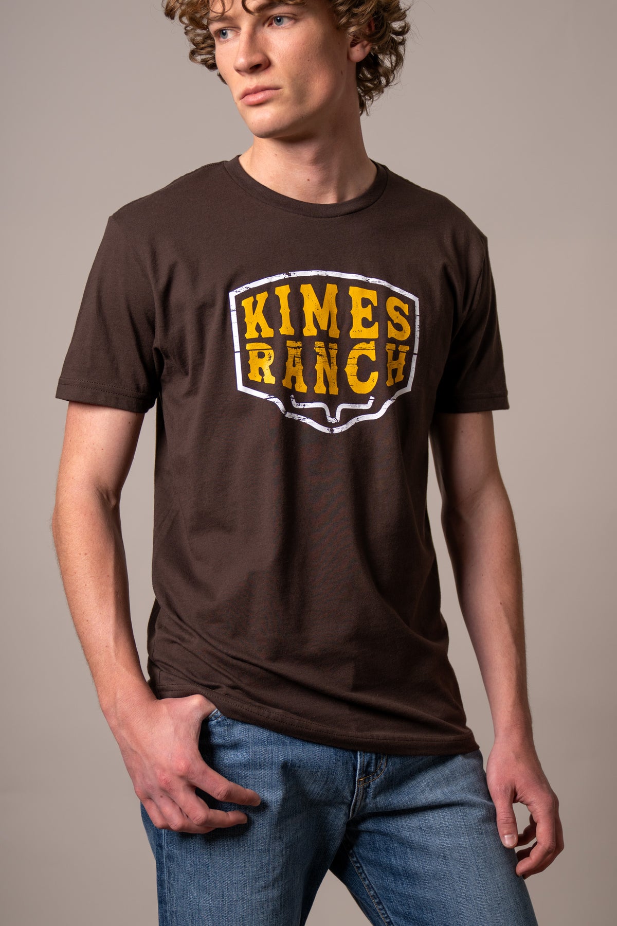 Kimes Ranch Wood Block shirt in Dark Chocolate with a yellow and white Kimes Ranch logo on the chest