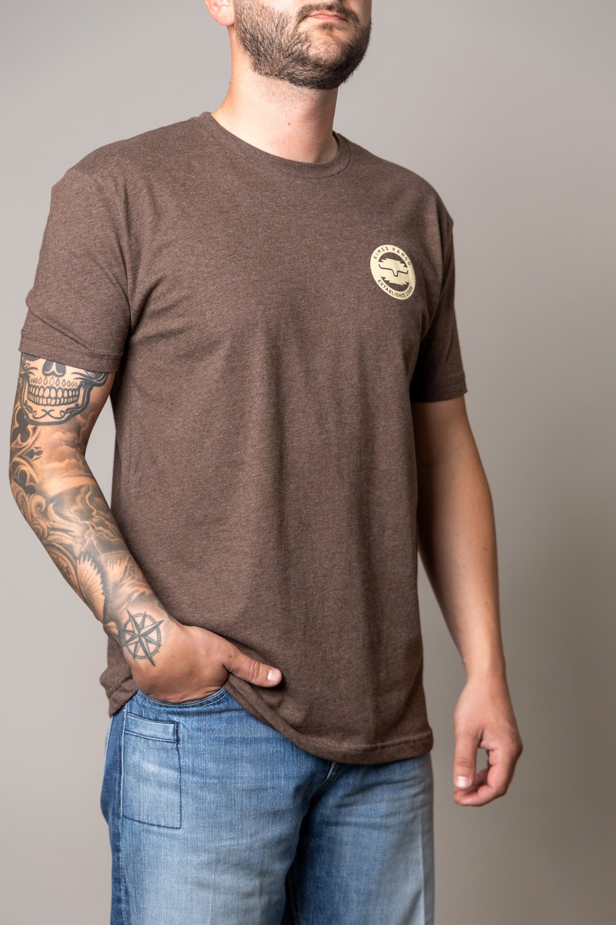 Kimes Ranch Wood Stamp shirt in Espresso with a short sleeve crew neck and a Kimes Ranch logo on the chest