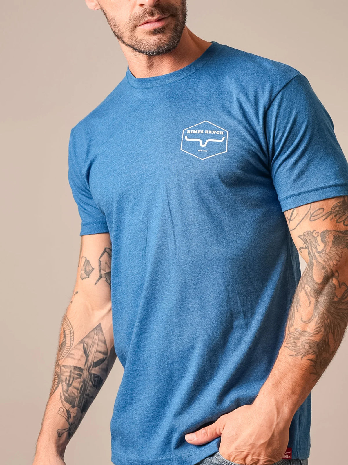 Kimes Ranch Wooden Hex shirt in Heather Cool Blue with a white hexagon logo on the chest