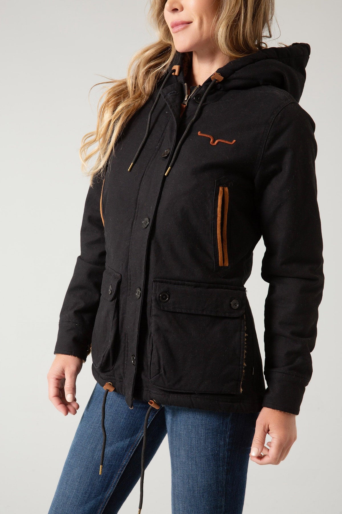 Kimes Ranch AWA Jacket in Black, side view, with a hood, front pockets, and a logo on the chest