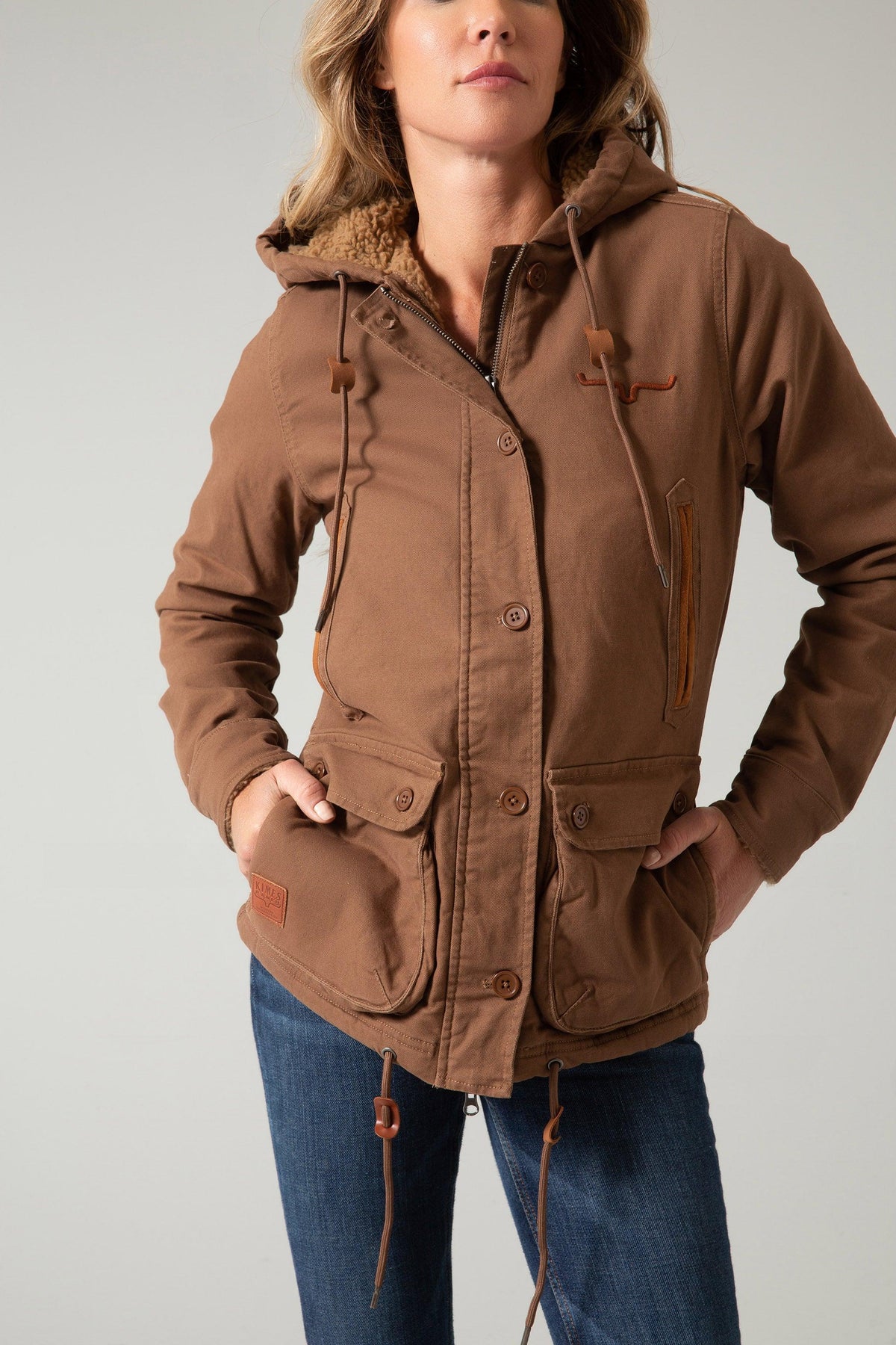 Kimes Ranch AWA Jacket in Brown with a sherpa-lined hood, front button closure, and flap pockets