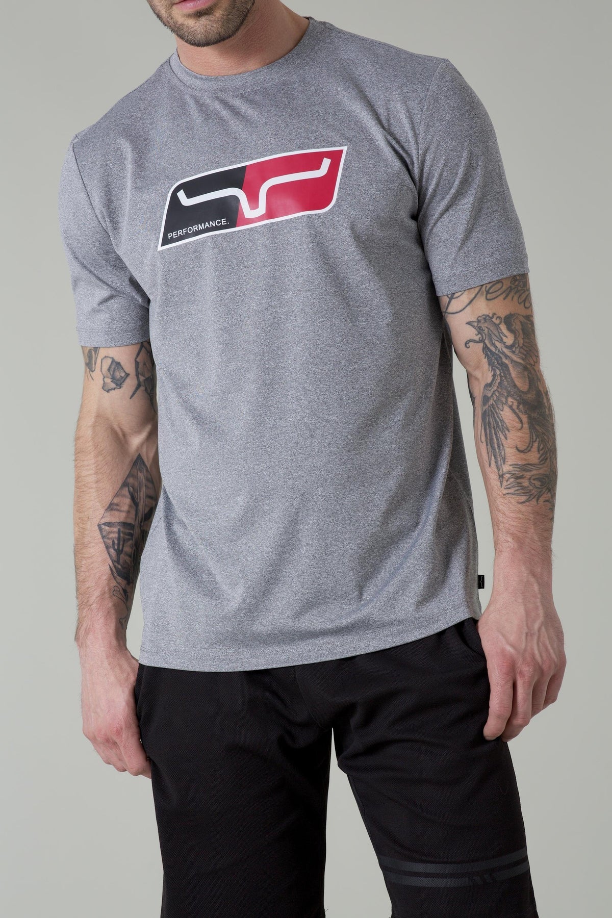 Kimes Ranch Alta Tech Tee Shirt in Grey Heather with a chest graphic featuring a stylized steer logo and the word PERFORMANCE