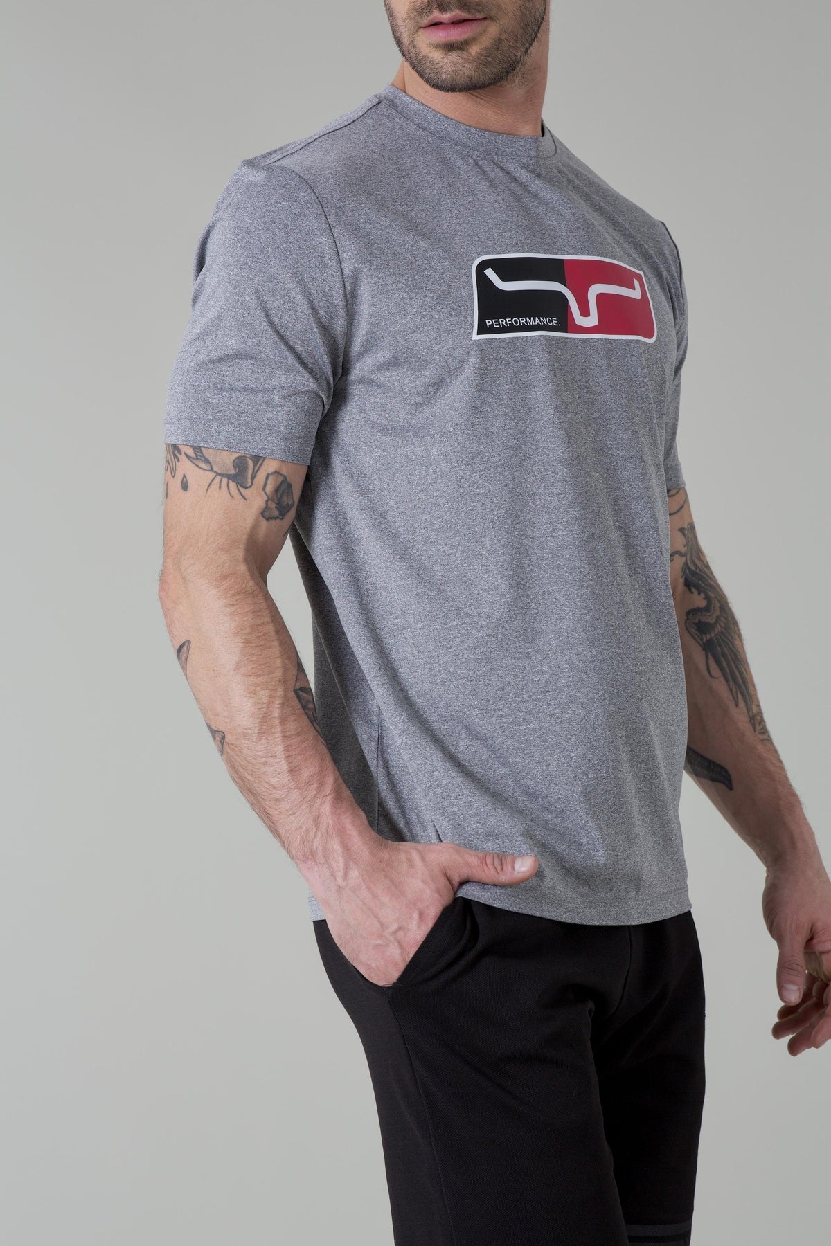 Kimes Ranch Alta Tech Tee Shirt in Grey Heather, side view, with chest graphic featuring stylized logo and word PERFORMANCE
