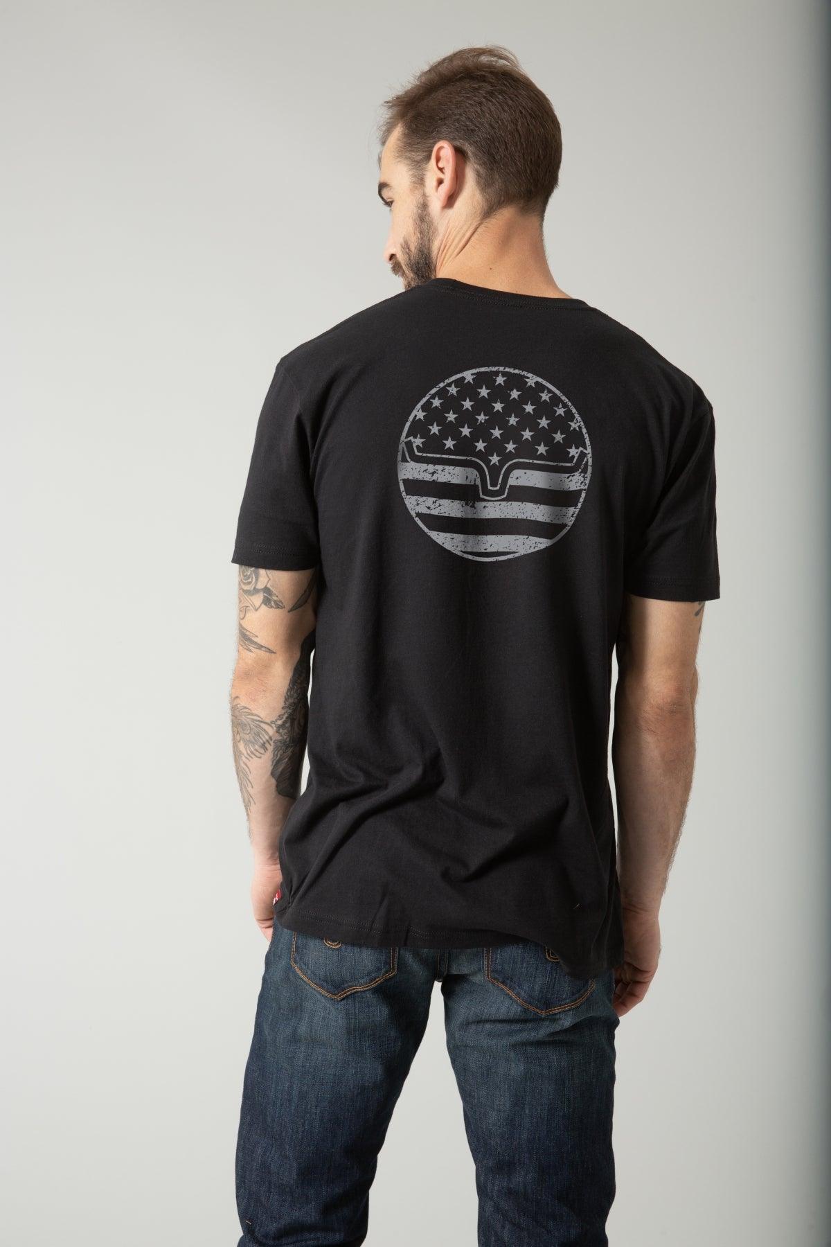Kimes Ranch American Bullseye Shirt in Black, back view, with a distressed circular graphic of stars and stripes on the back