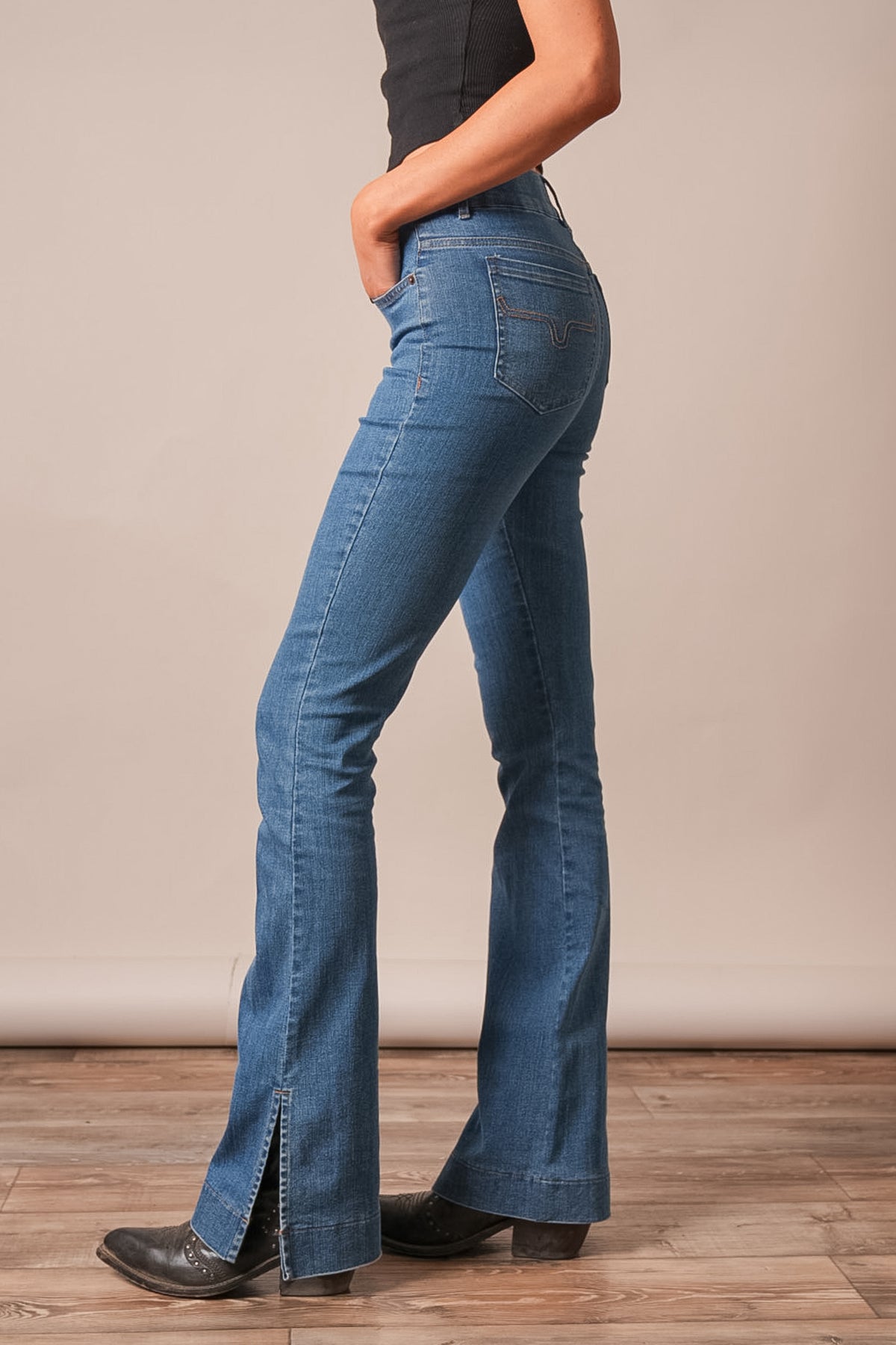 Kimes Ranch Aster jeans in Indigo, side view, with a bootcut silhouette and a hem slit