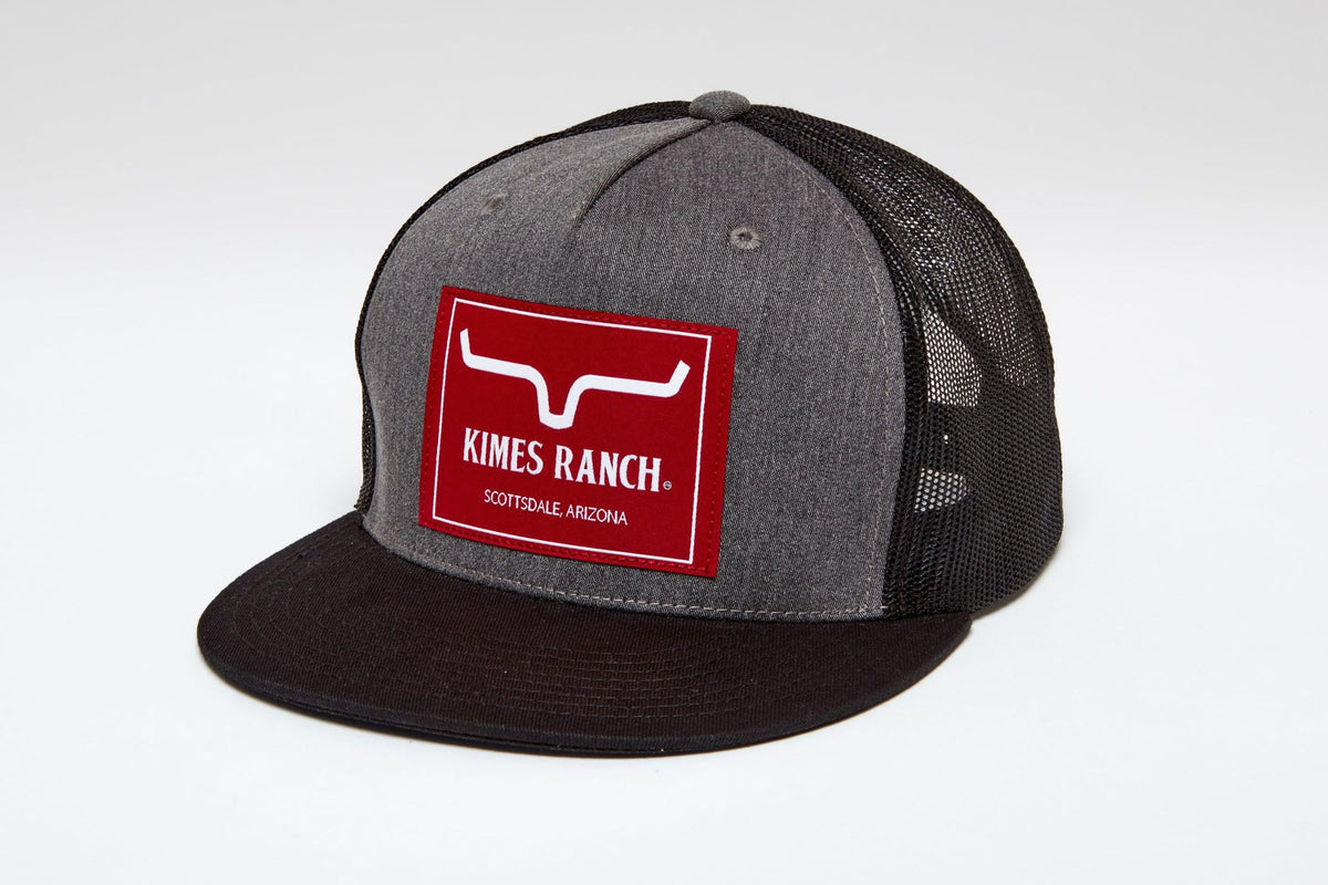 Kimes Ranch Blaster Trucker Hat in Charcoal Heather, side view, with a red logo patch and black mesh back