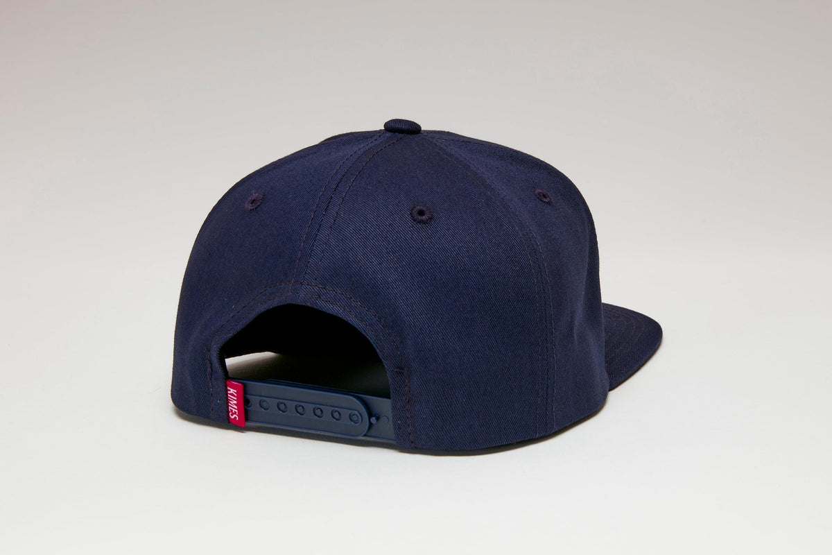 Kimes Ranch Canyon Country Hat in Navy, back view, with a red Kimes Ranch logo tag on the adjustable strap