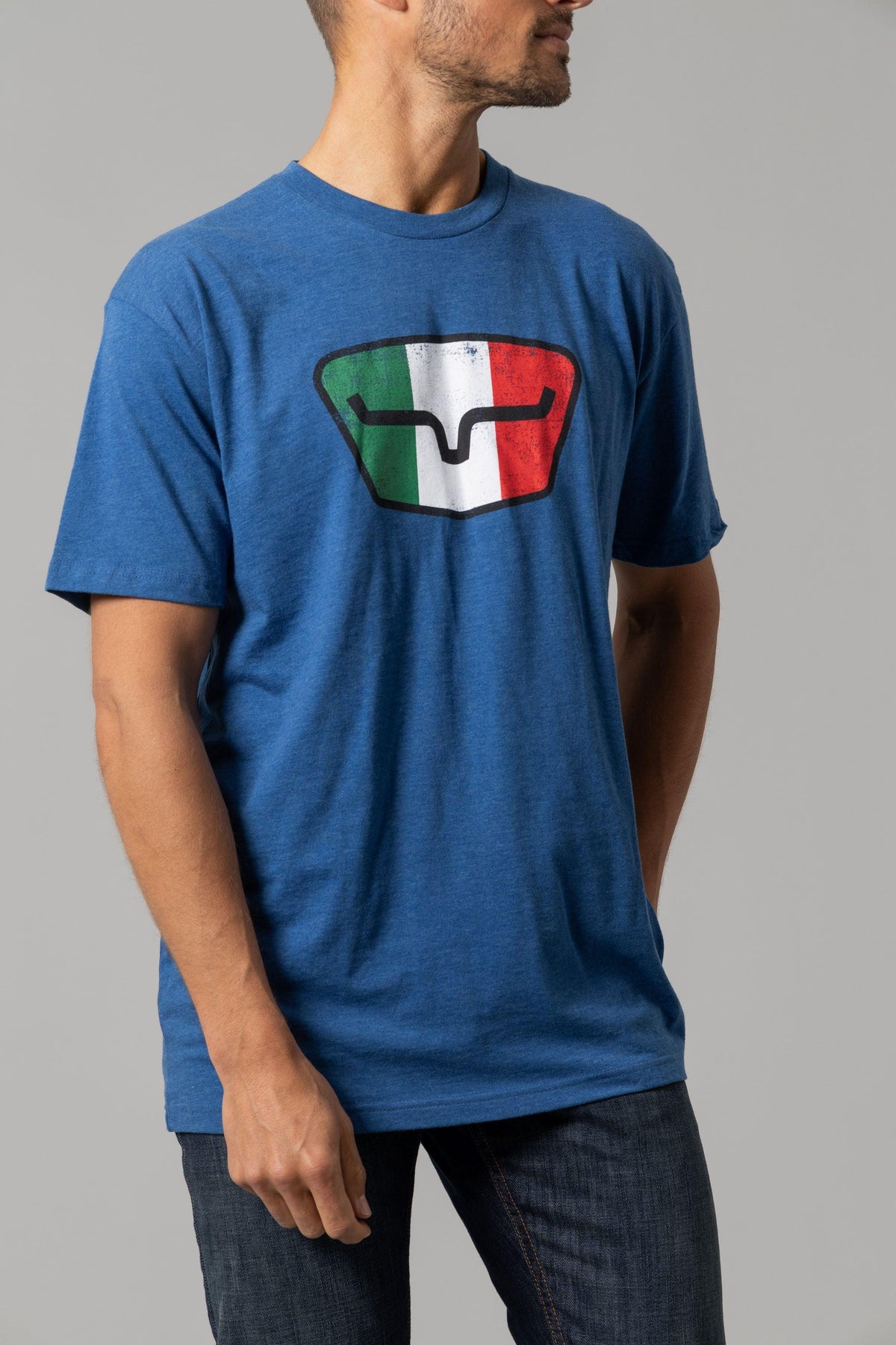 Kimes Ranch Tri-Color Tee in Heather Cool Blue with a shield graphic featuring the Italian flag colors