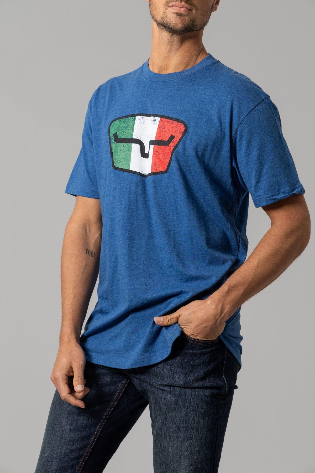 Kimes Ranch Tri-Color Tee in Heather Cool Blue with a graphic of a the Kimes Ranch logo in the Italian flag colors
