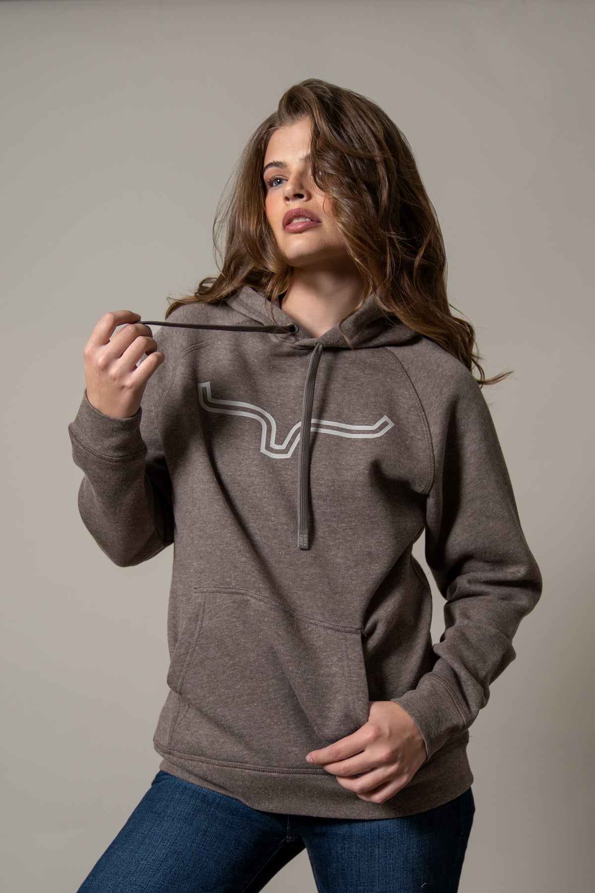 Kimes Ranch Ladies Outlier Hoodie in Dark Brown with a long sleeve silhouette and a front kangaroo pocket