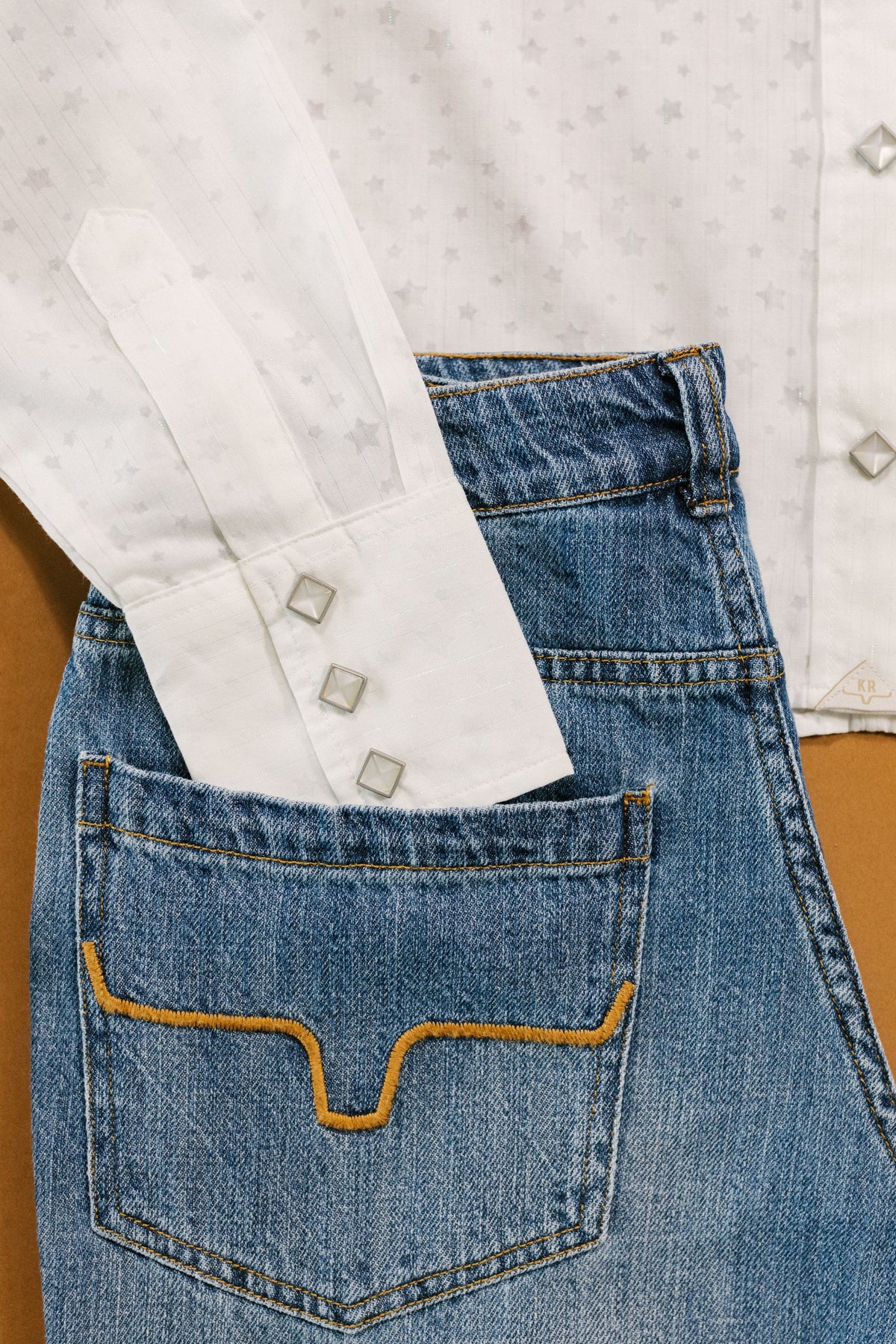 Kimes Ranch Etoile top in Pristine, close-up, with a star pattern and three square cuff buttons