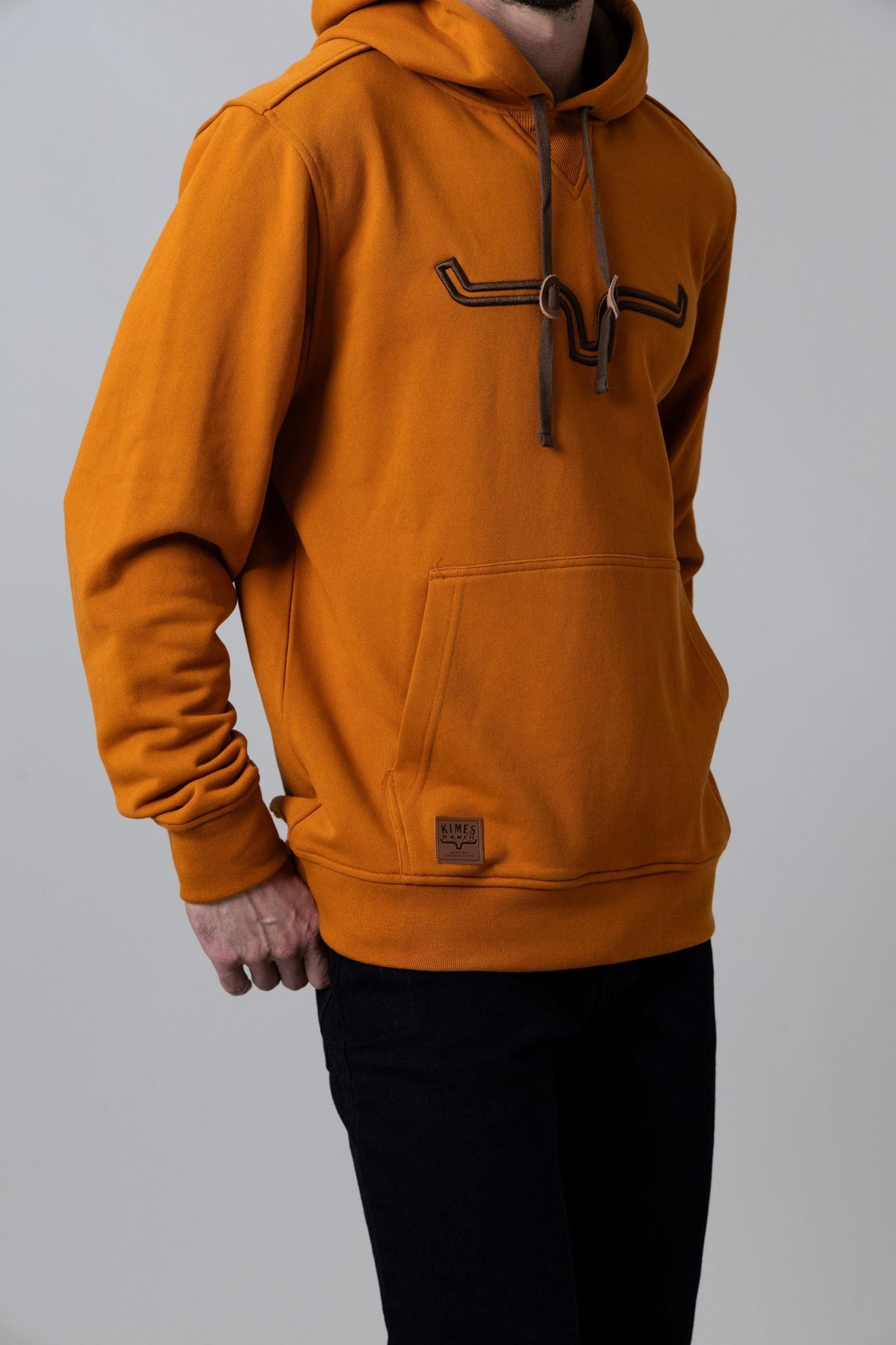 Kimes Ranch Fast Talker Hoodie in Burnt Orange with long sleeves and a front kangaroo pocket