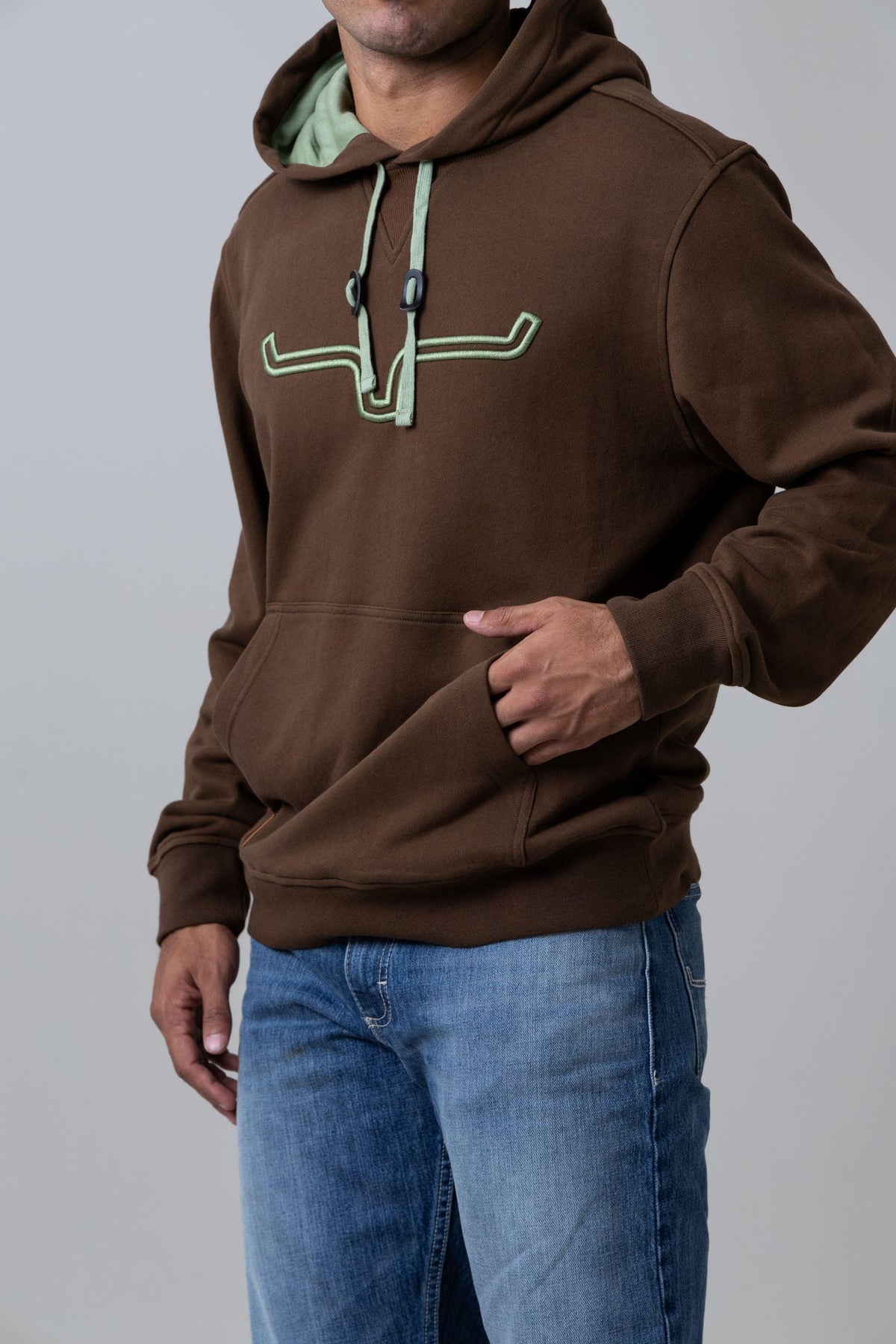 Kimes Ranch Fast Talker Hoodie in Dark Brown with a green embroidered logo and kangaroo pocket